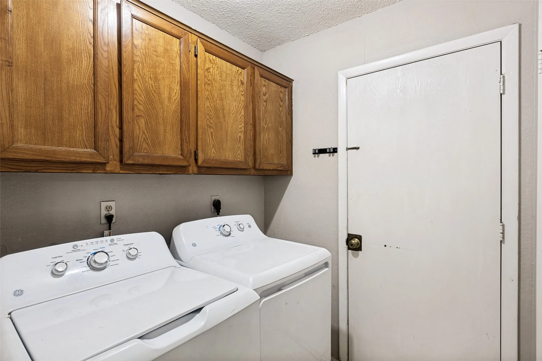 Wall-mounted wood cabinetry with paneled doors