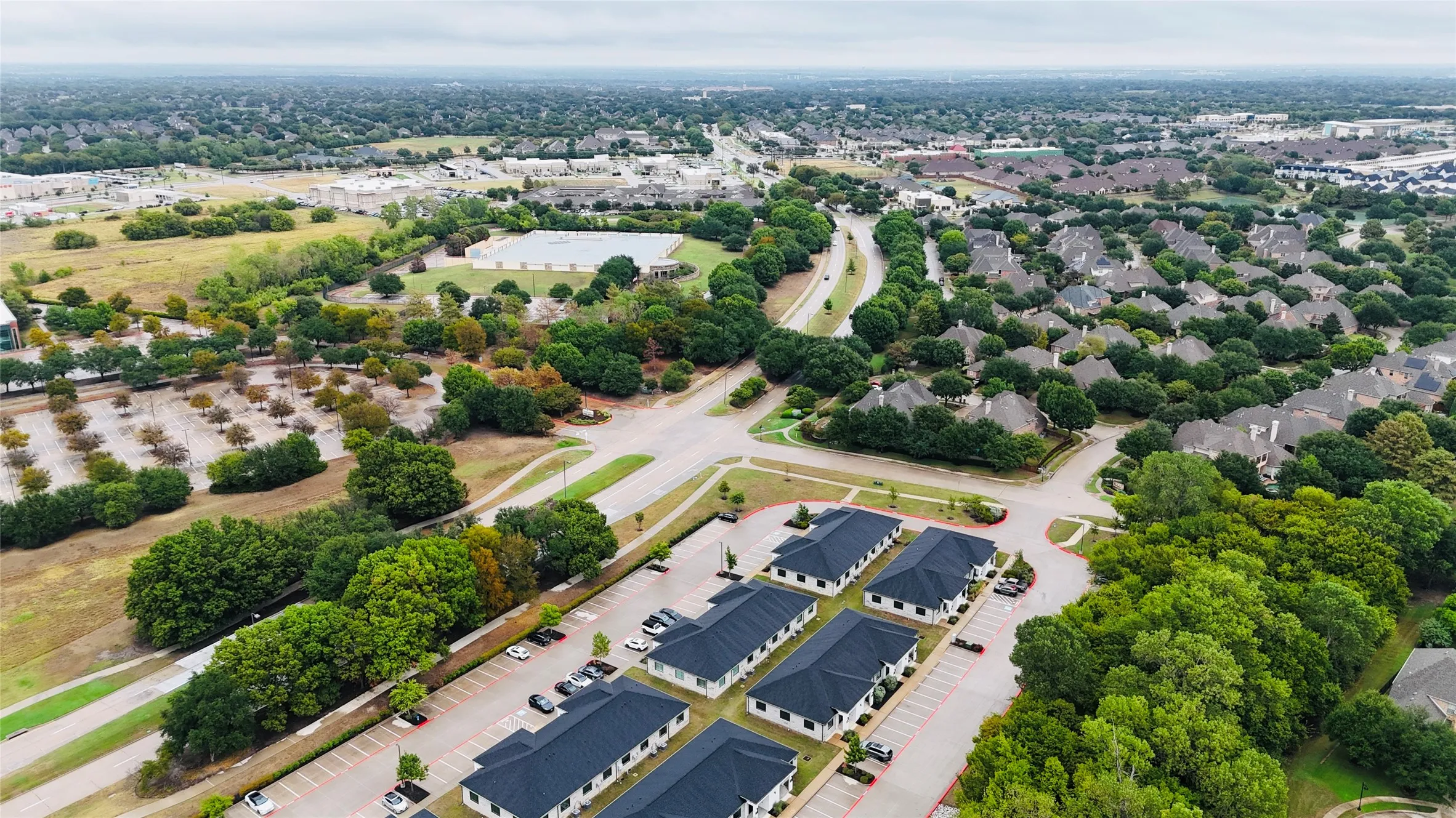 Expansive residential area featuring numerous single-family homes, mature trees, and a network of paved roads