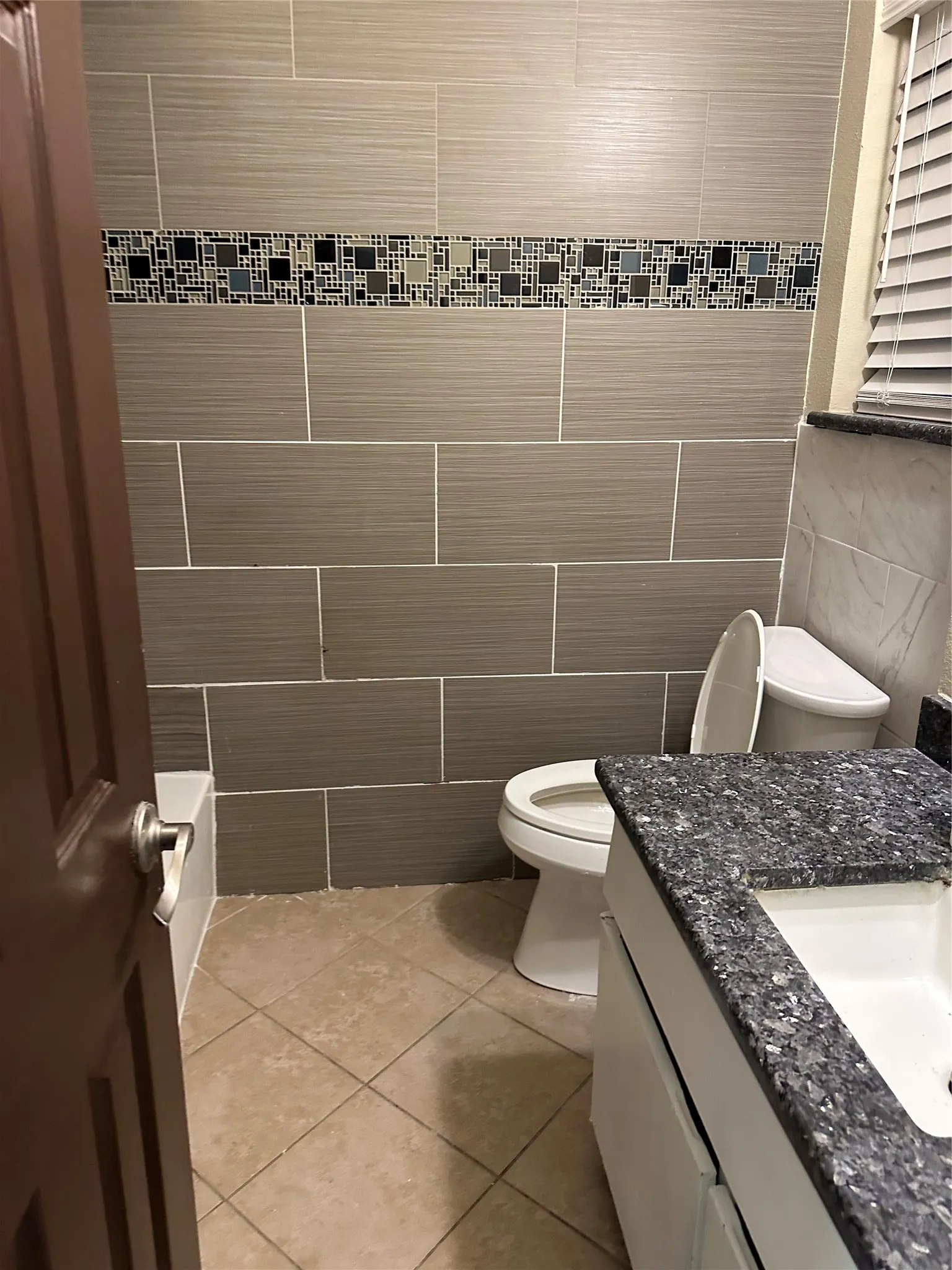 Rectangular wall tiles with a decorative mosaic accent band