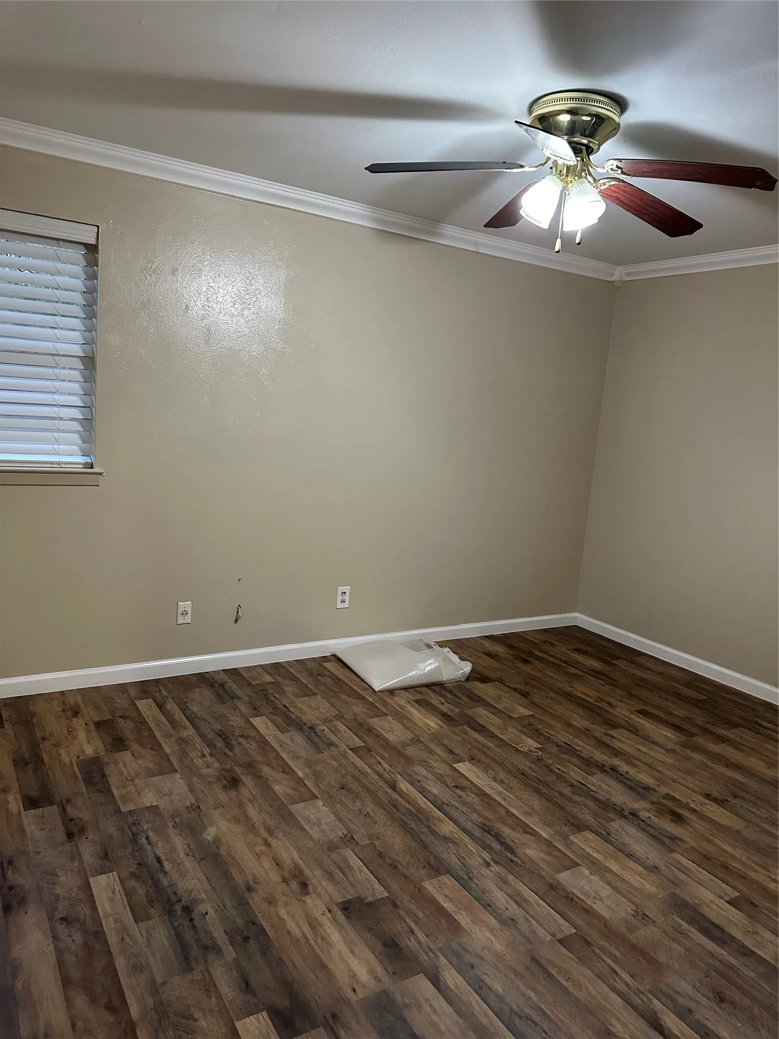 Wood-finish flooring with crisp white baseboards
