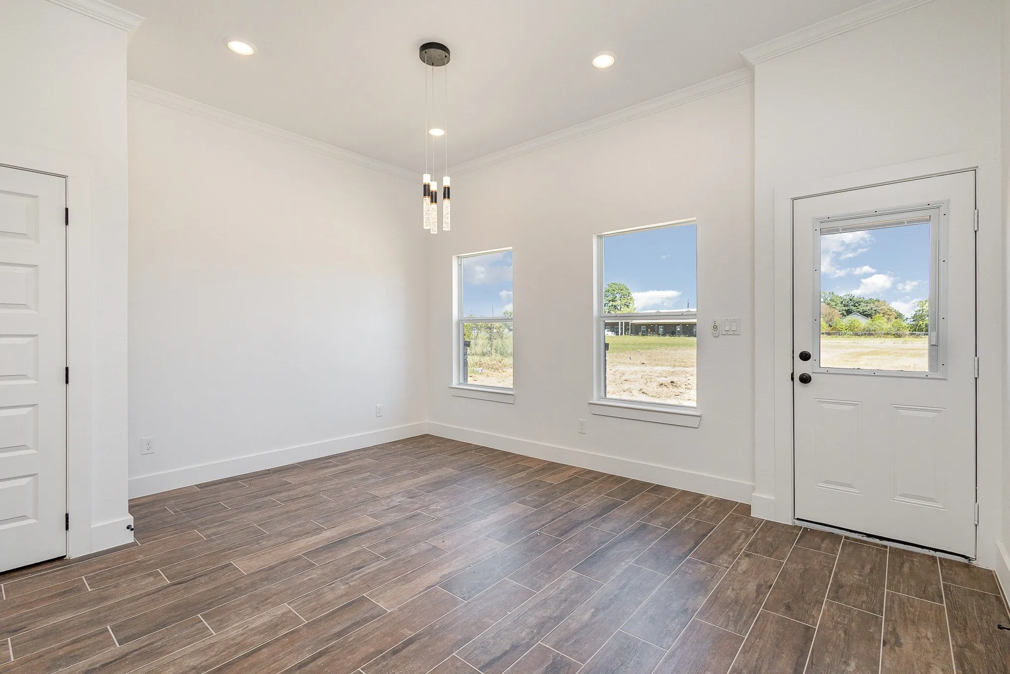 Large area with decorative lighting, 2 windows & back door.