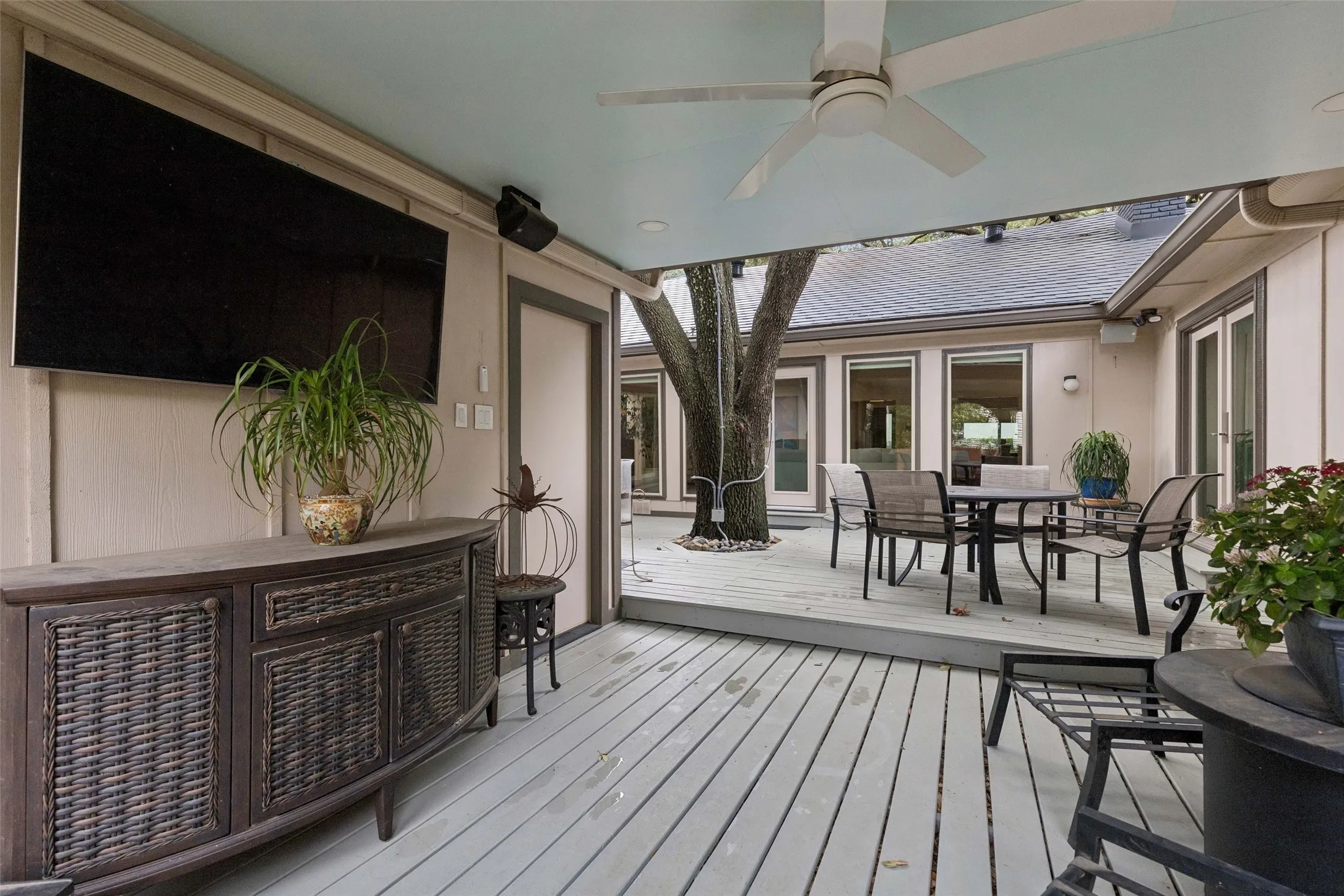 Covered Outdoor Living — A covered patio extends the usable living space outdoors with room for seating, dining, and enjoying the backyard in a more sheltered setting.