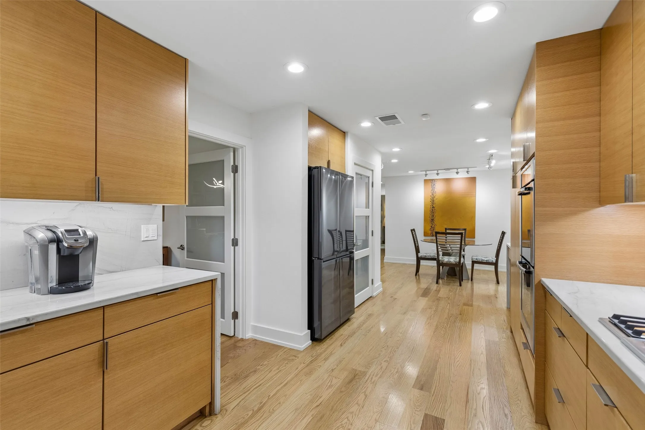Easy Connection from Kitchen to Dining — This angle highlights the kitchen's direct flow into the casual dining area, making meals, conversation, and entertaining feel naturally connected.