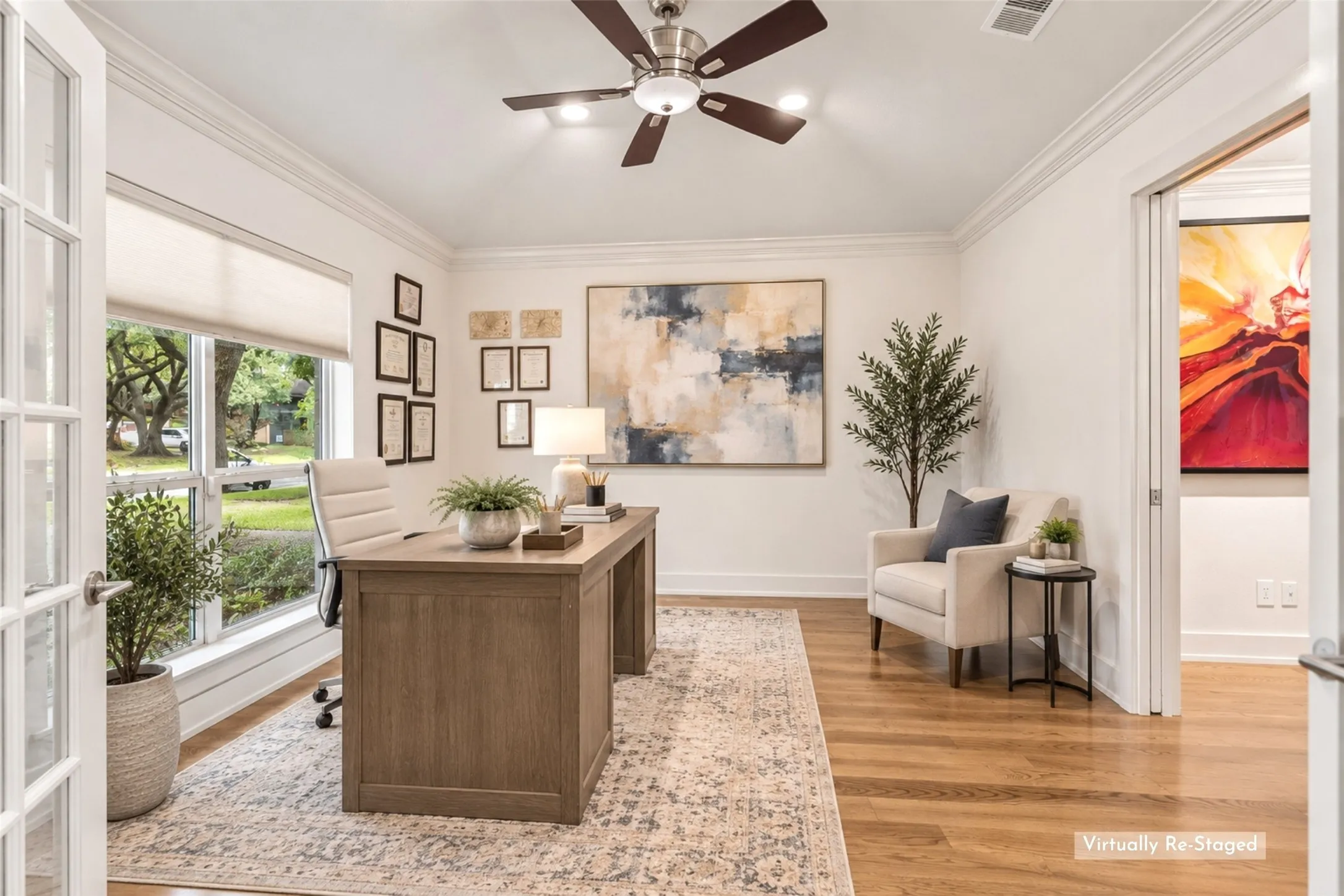 A Dedicated Office with Natural Light — French doors, hardwood flooring, a large window, and a comfortable footprint create a private workspace that feels connected to the home while still offering separation for focused work.