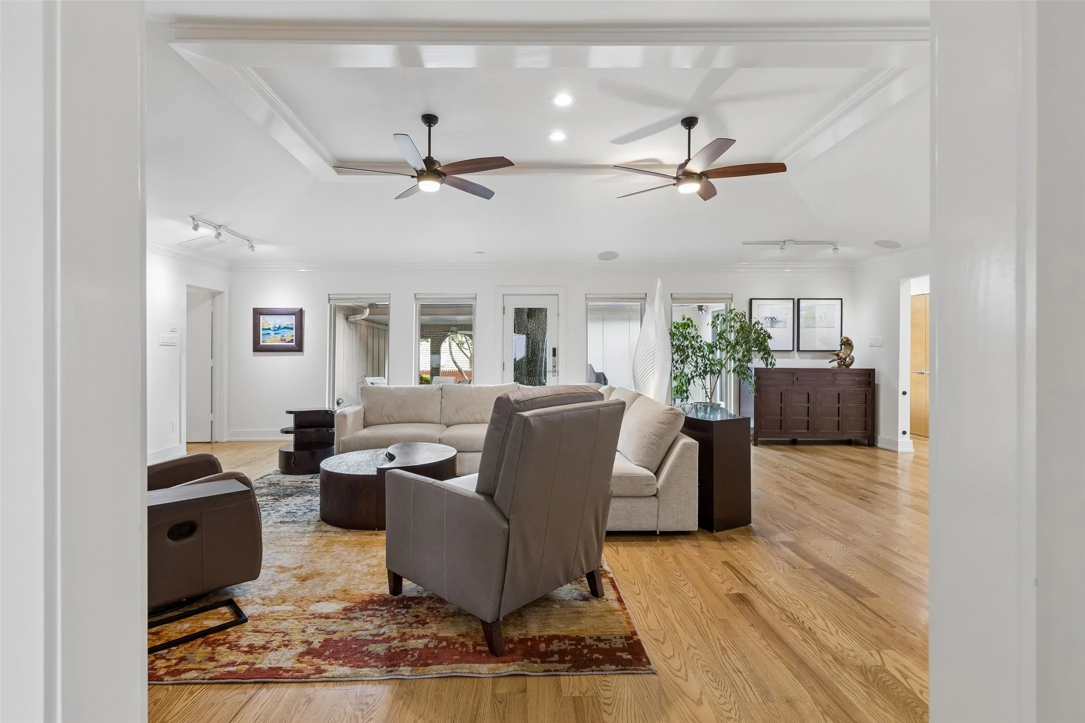 Indoor-Outdoor Connection — A wall of windows and exterior access fill the living area with natural light while creating an easy transition to the backyard and covered outdoor living spaces.
