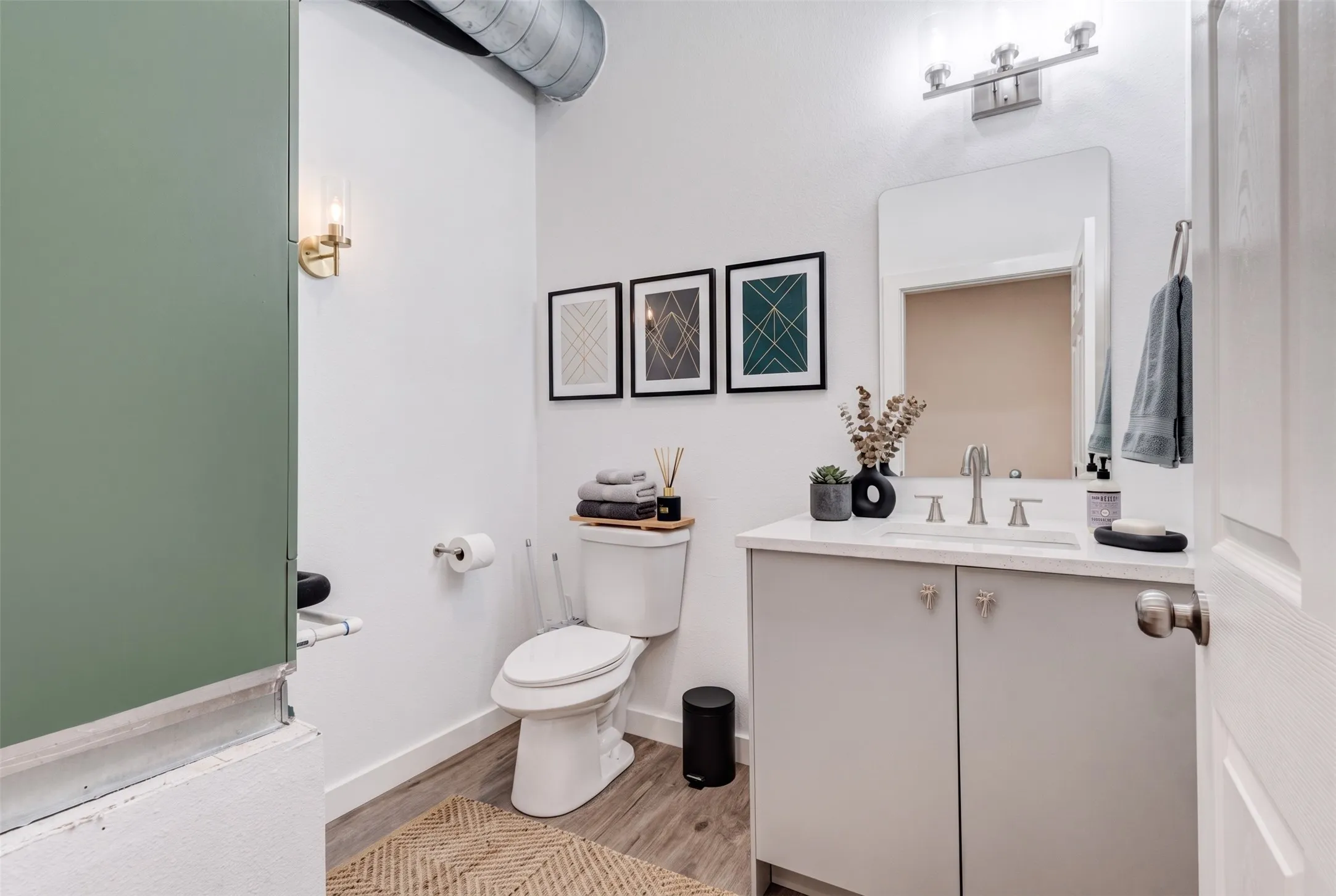 White vanity with a light-toned countertop and an undermount sink - AI Generated