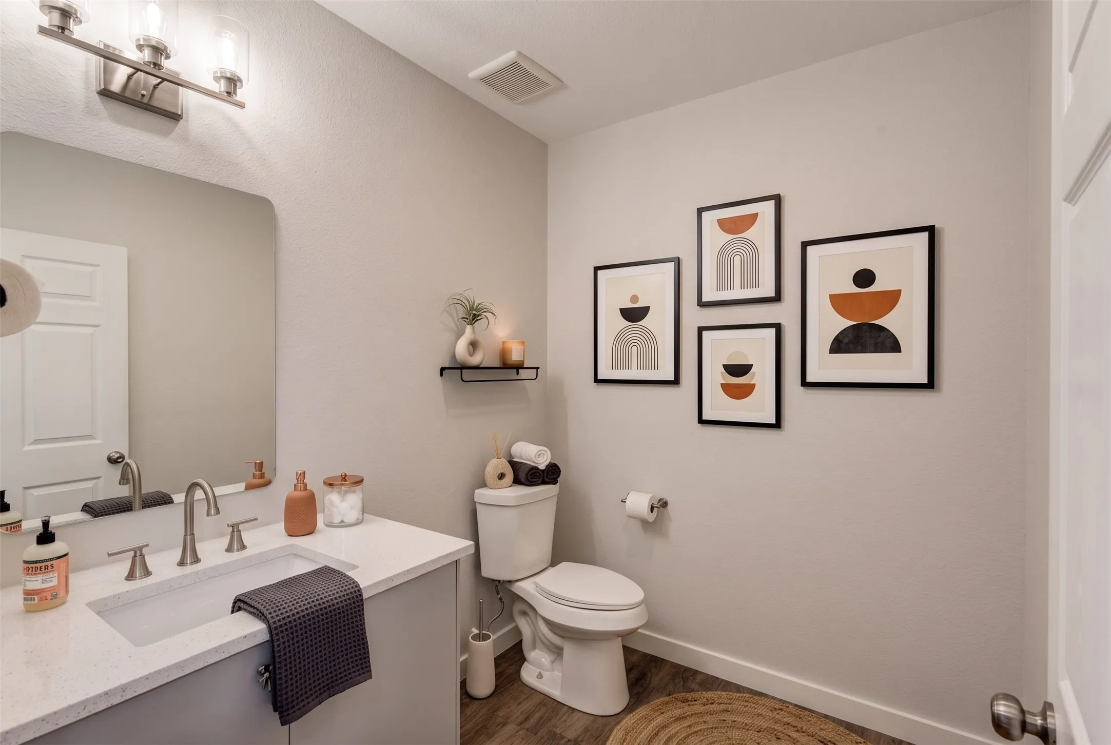 Vanity with an integrated rectangular sink, brushed nickel faucet, and a light-colored countertop