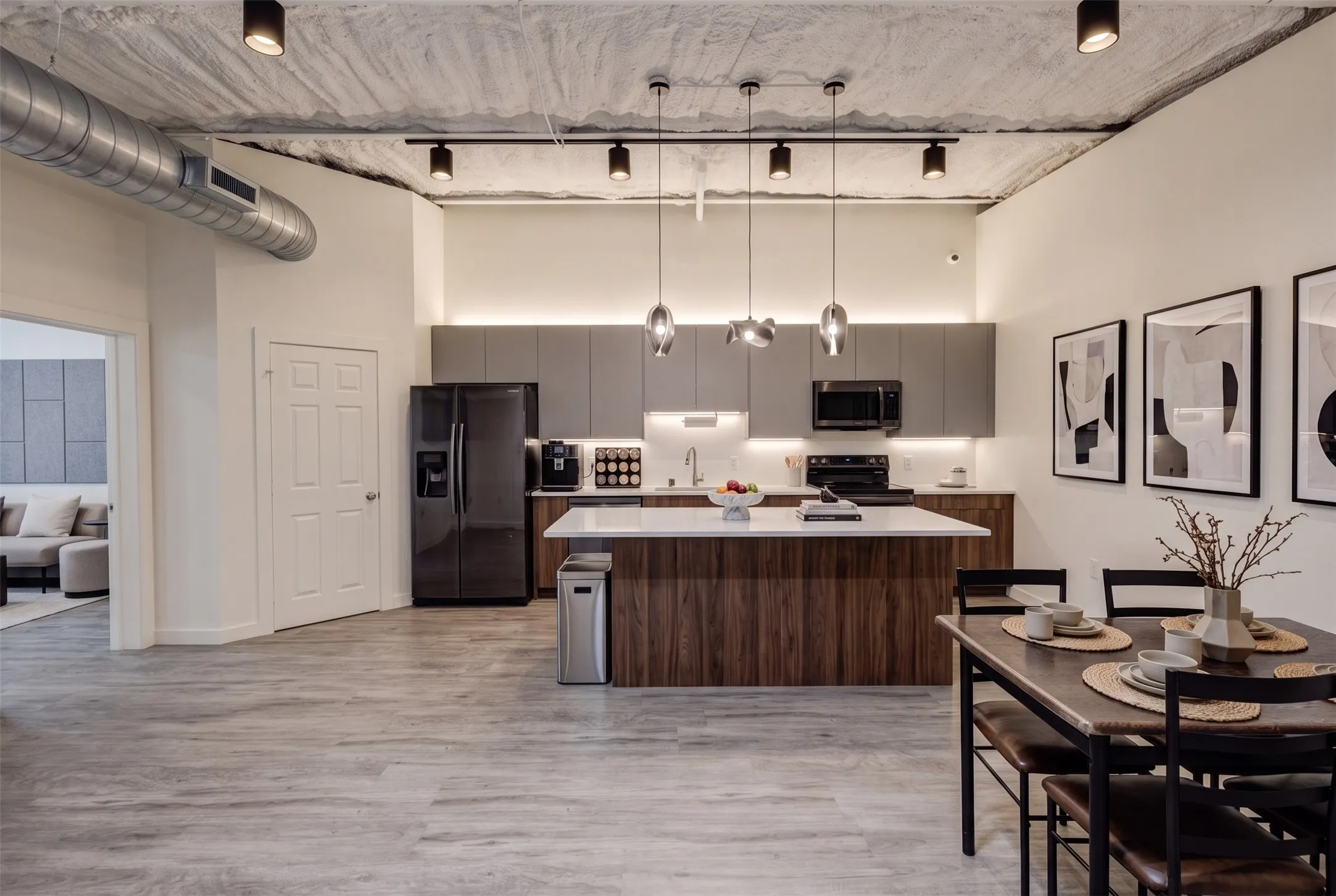 Modern kitchen featuring dark wood-finish cabinetry, stainless steel appliances, and a central island with a light-toned countertop - AI Generated