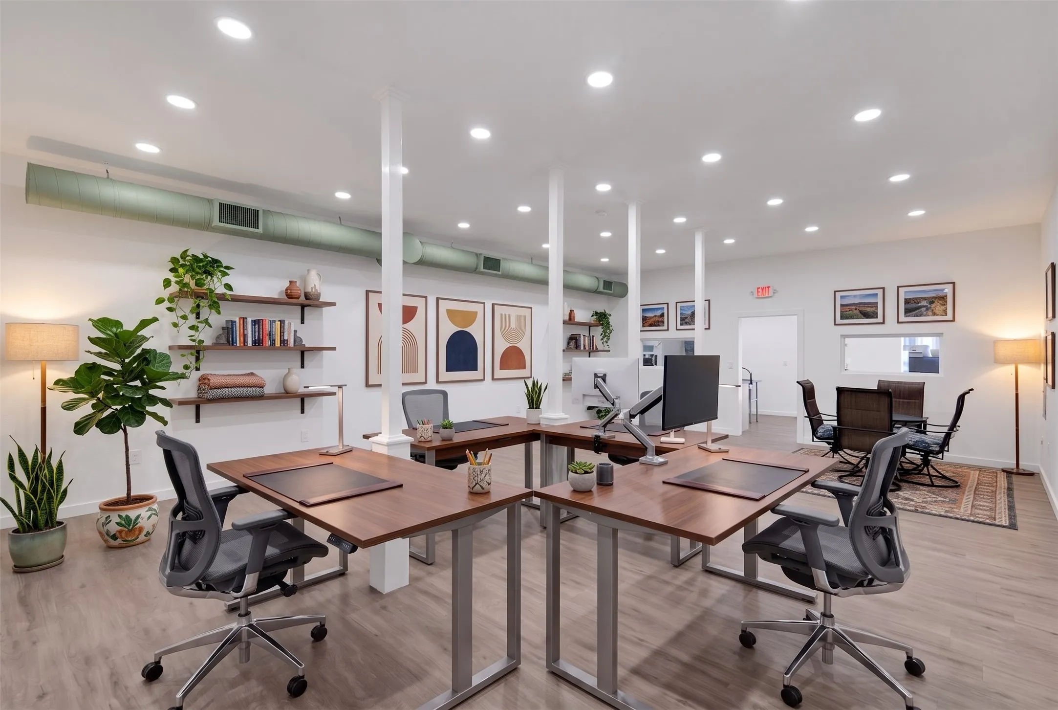 Recessed ceiling lighting, exposed ductwork, wood-finish flooring, built-in shelving, and white interior walls - AI Generated