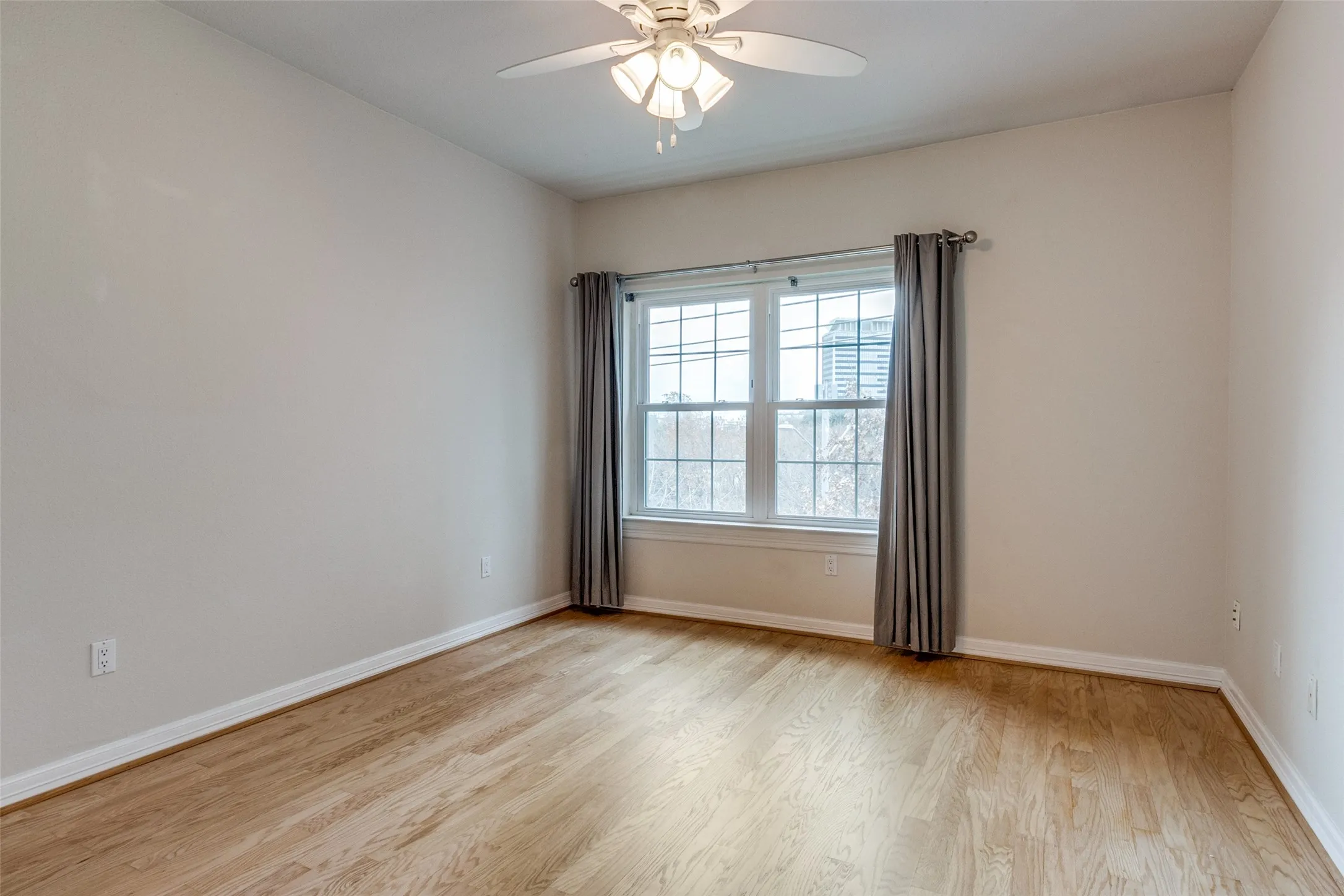Master bedroom with wood like flooring.