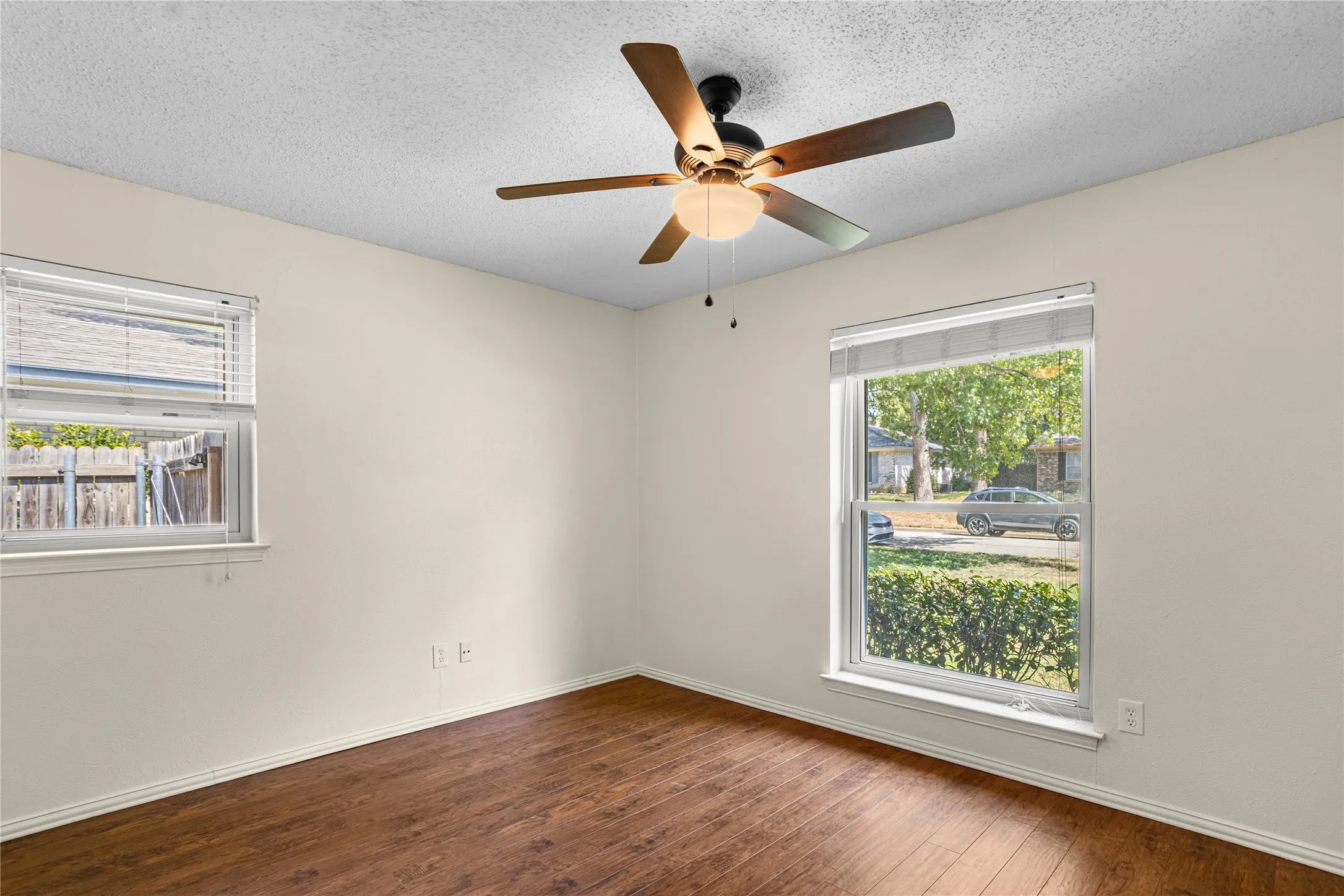 Wood-finish flooring with a ceiling fan light fixture