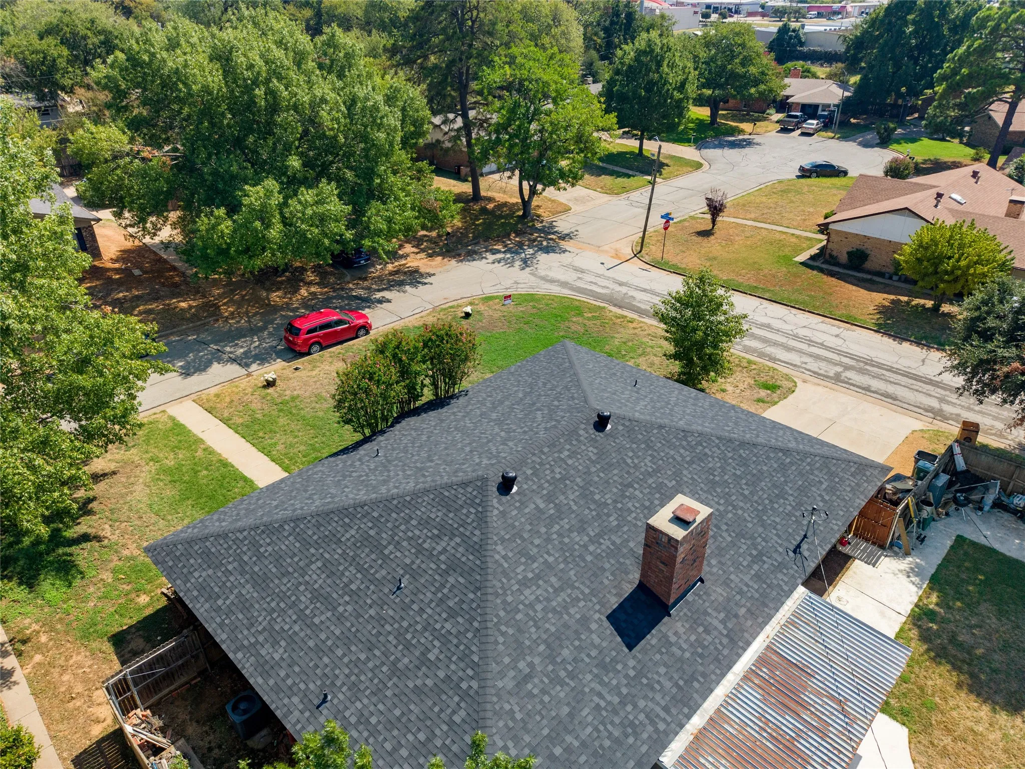 Asphalt shingle roof with a brick chimney