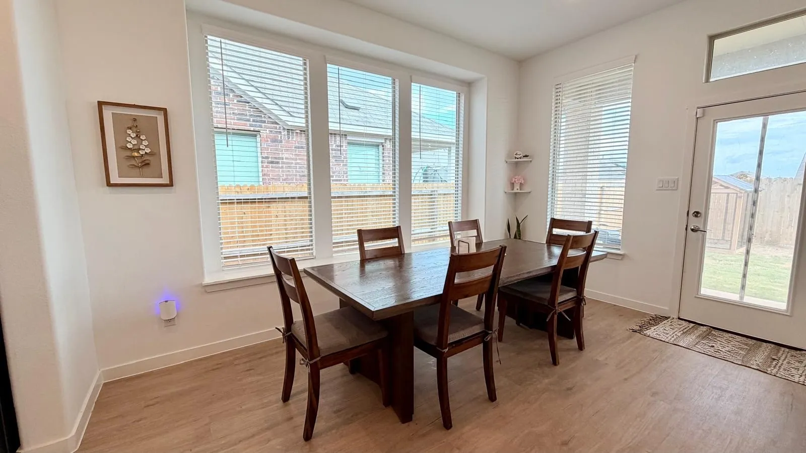 Dining area featuring wood-finish flooring and white baseboards