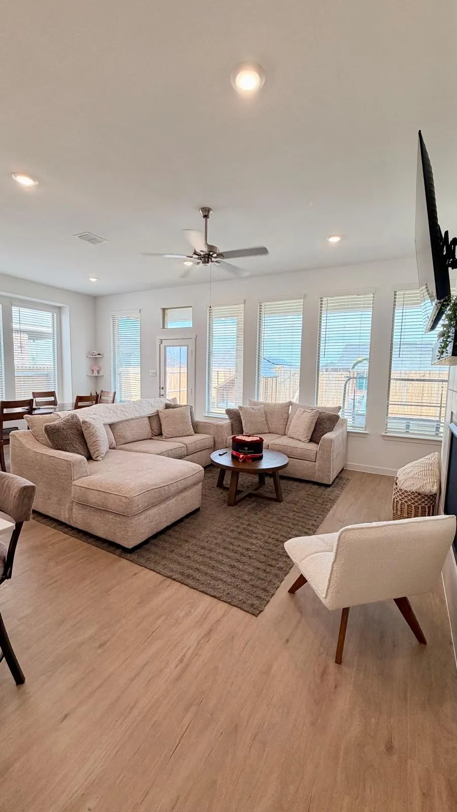 Open-concept living space featuring wood-finish flooring, recessed lighting, and a ceiling fan