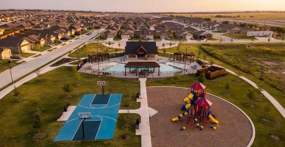 Community amenities featuring a central clubhouse, swimming pool, basketball court, and playground