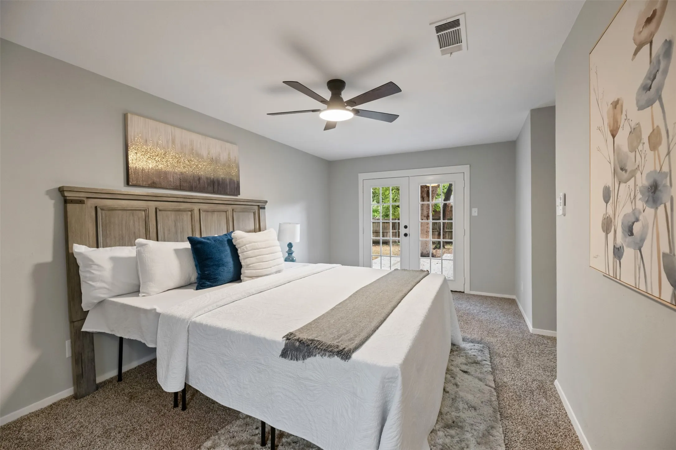 The primary bedroom has double doors that lead to the back deck as well as a walk in closet