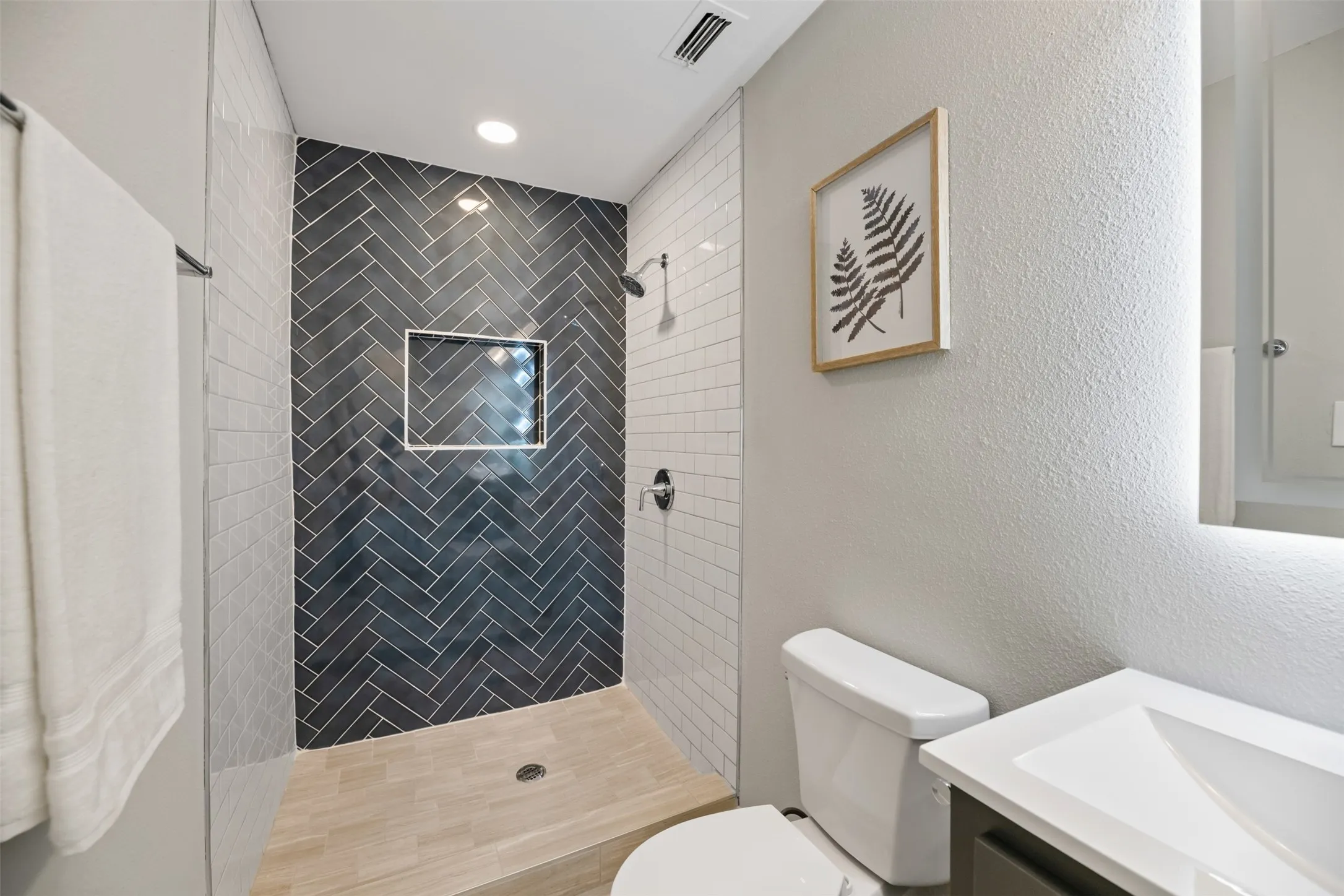 Primary shower with new faucet and tile surround