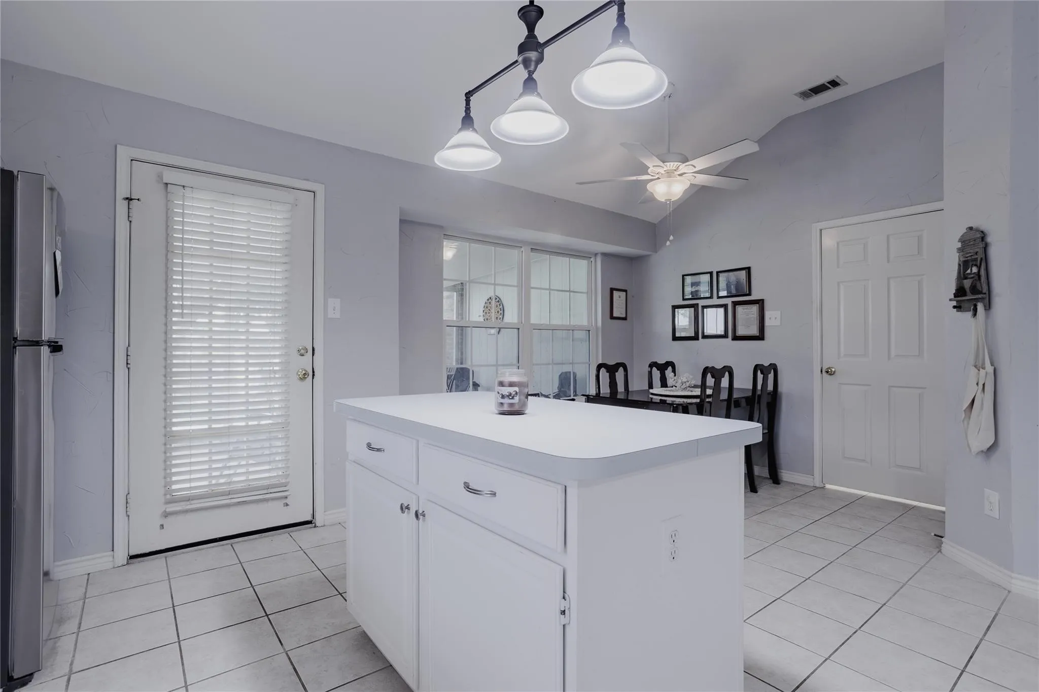 Central kitchen island with white cabinetry and a white countertop