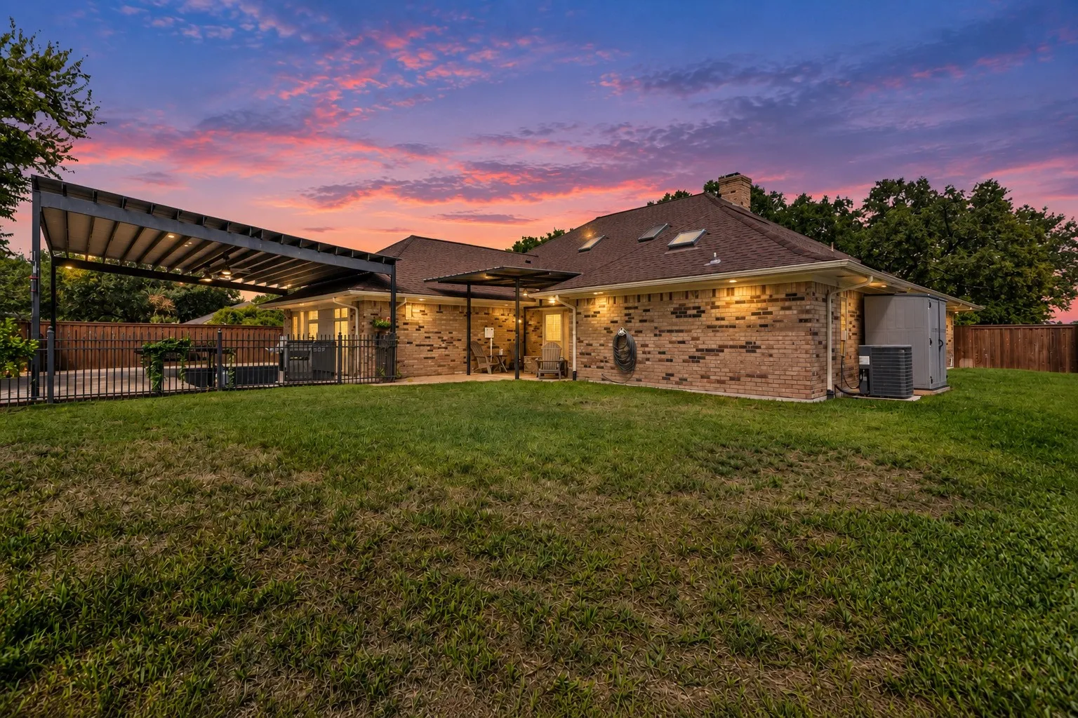Back of house and backyard at sunset of 7104 Church Park Dr, Ft Worth TX 76133 in the Candleridge Addition