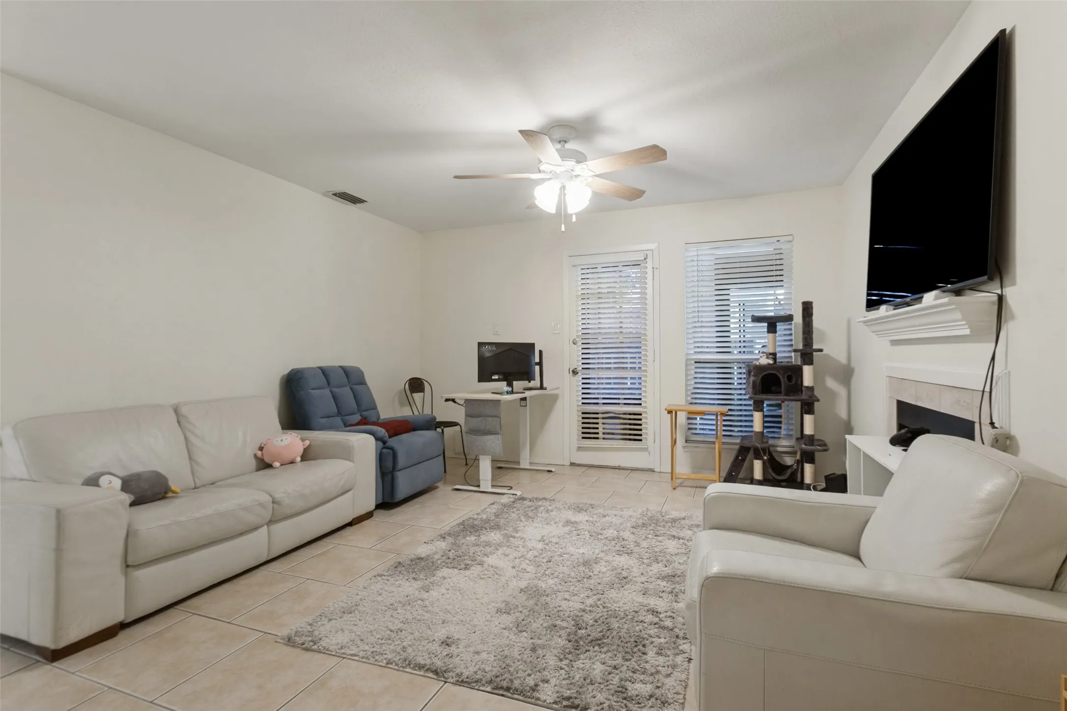 Recessed lighting, tile flooring, ceiling fan, and a built-in fireplace