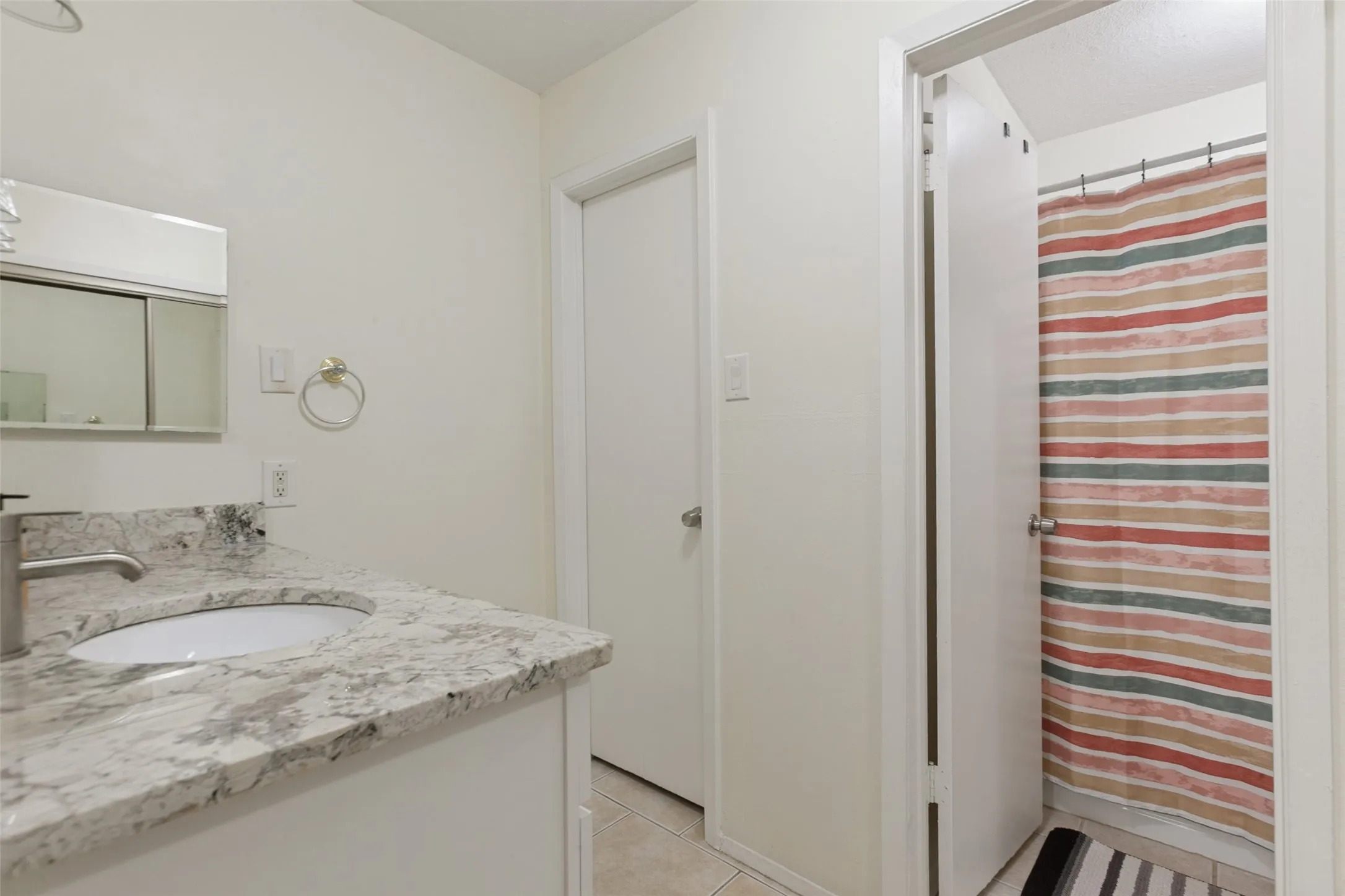 White vanity with a white countertop and integrated sink