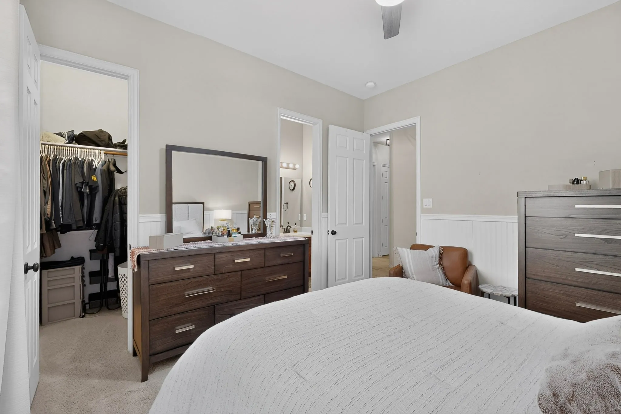Recessed lighting, ceiling fan, white paneled wainscoting, and carpeted flooring