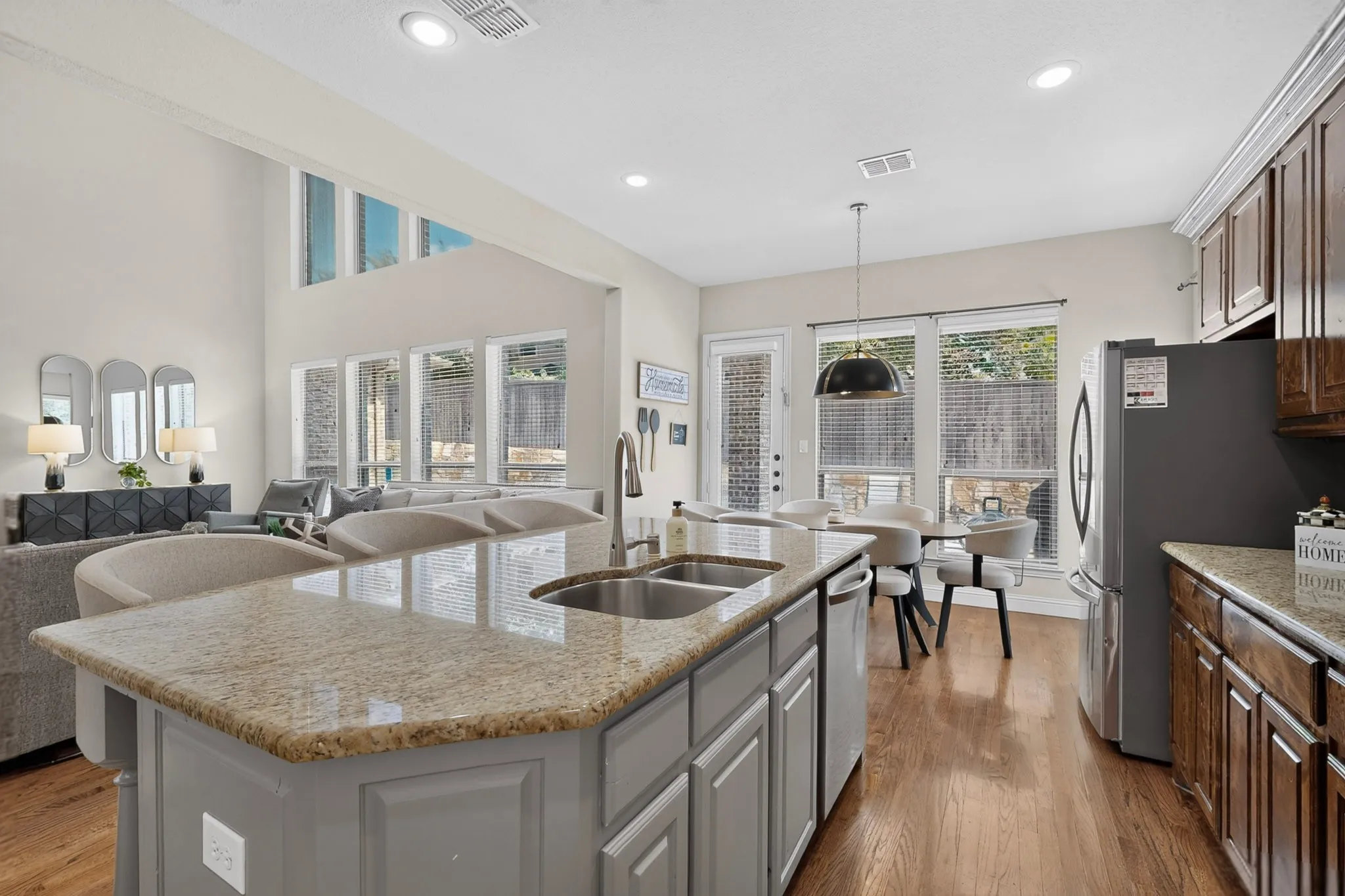 Kitchen island with an undermount double-basin sink and a granite-finish countertop