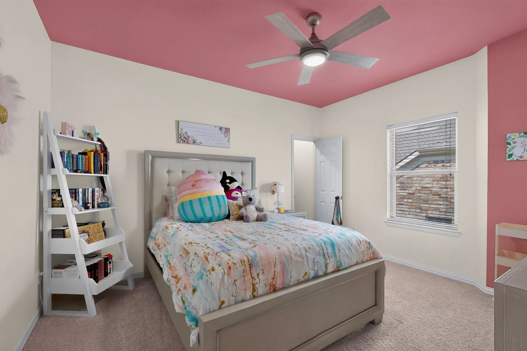Neutral wall paint with a contrasting ceiling color, ceiling fan with integrated lighting, and carpeted flooring
