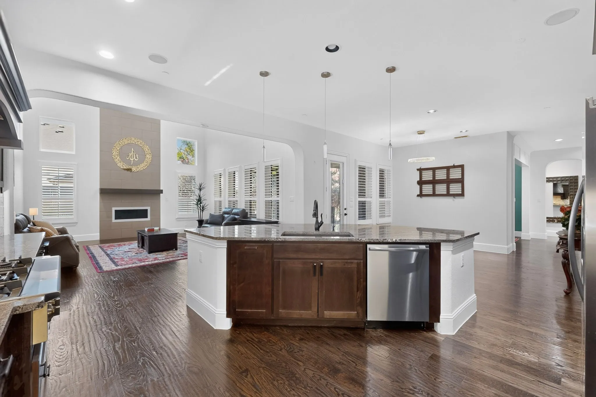 Open-concept living space with dark wood-finish flooring