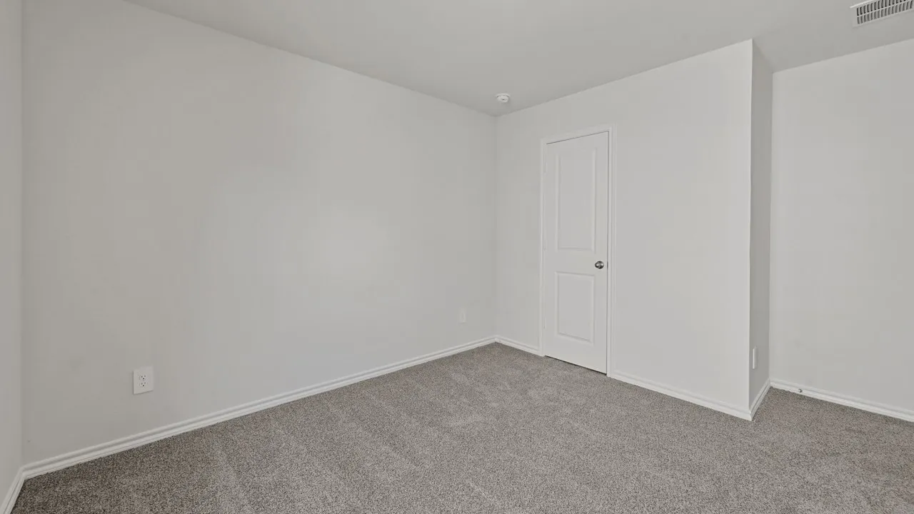 Neutral-toned wall paint throughout, complemented by light gray carpeting