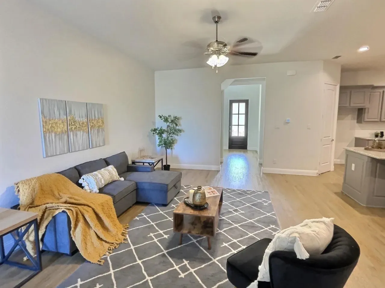 Recessed lighting, wood-finish flooring, ceiling fan, archway entry, and light gray wall paint