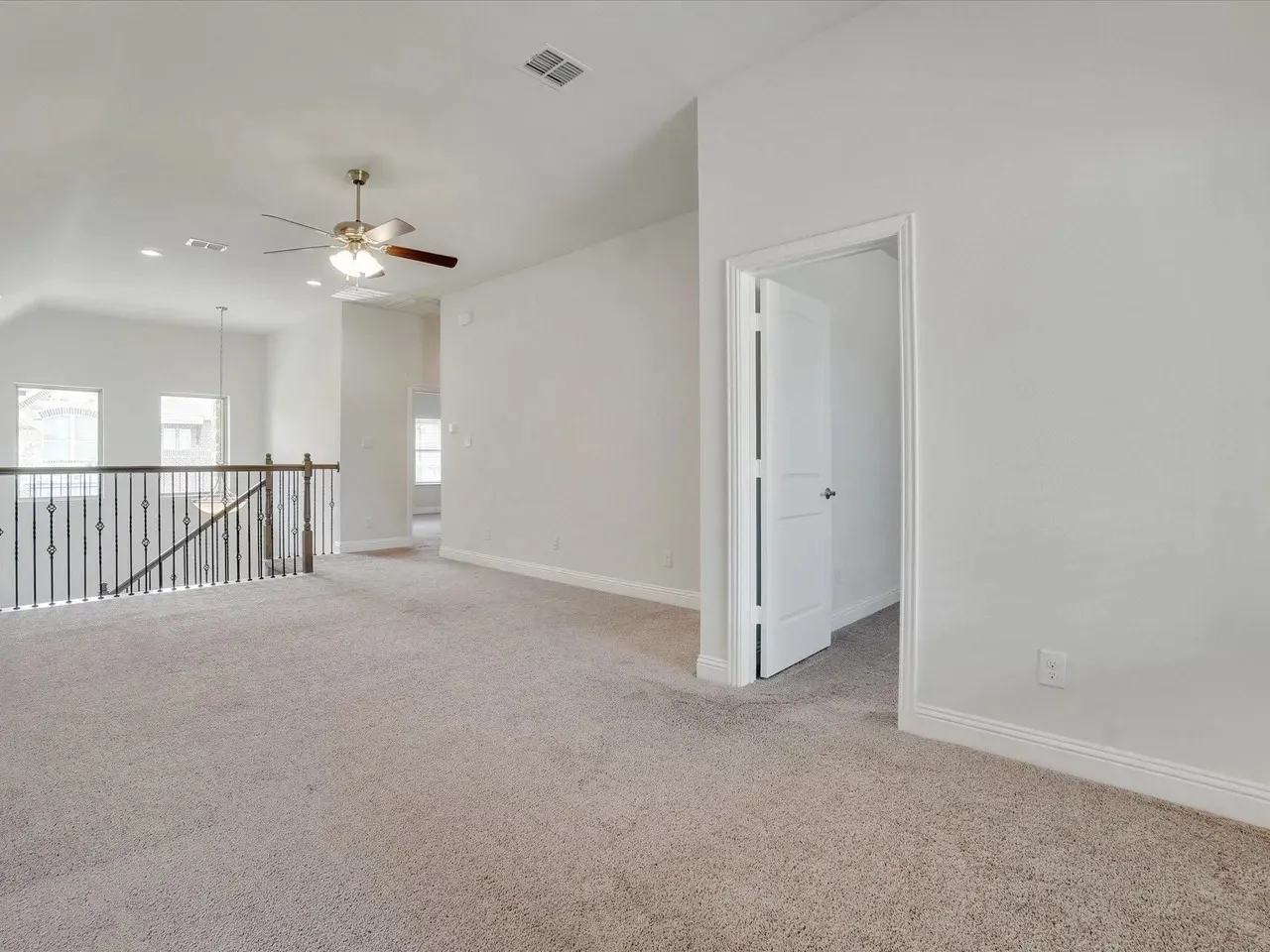 Carpeted loft space featuring an open doorway, recessed lighting, and a ceiling fan