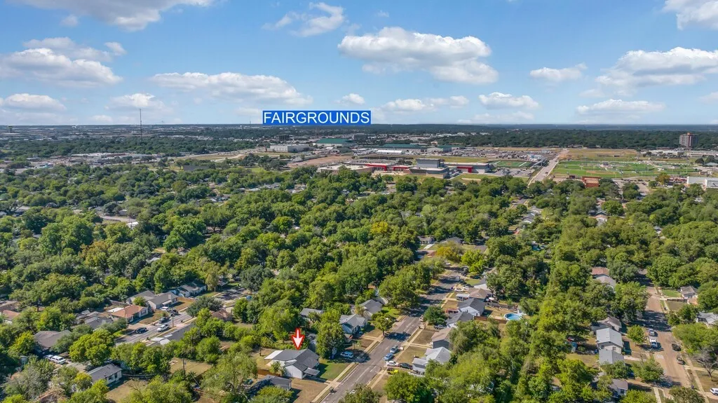 Aerial perspective of a residential area with dense tree canopy