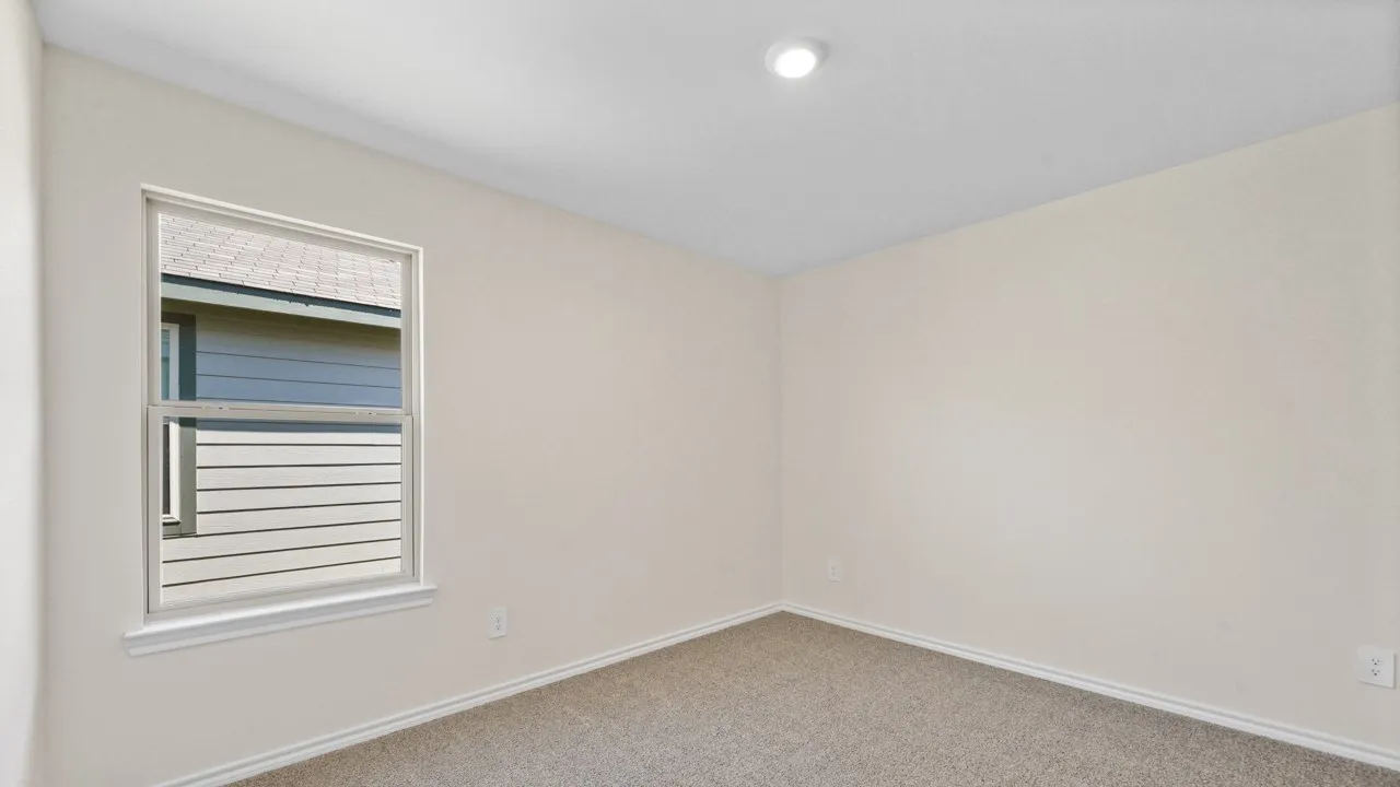 Light-filled room featuring neutral wall paint, recessed lighting, a framed window, and plush carpeting