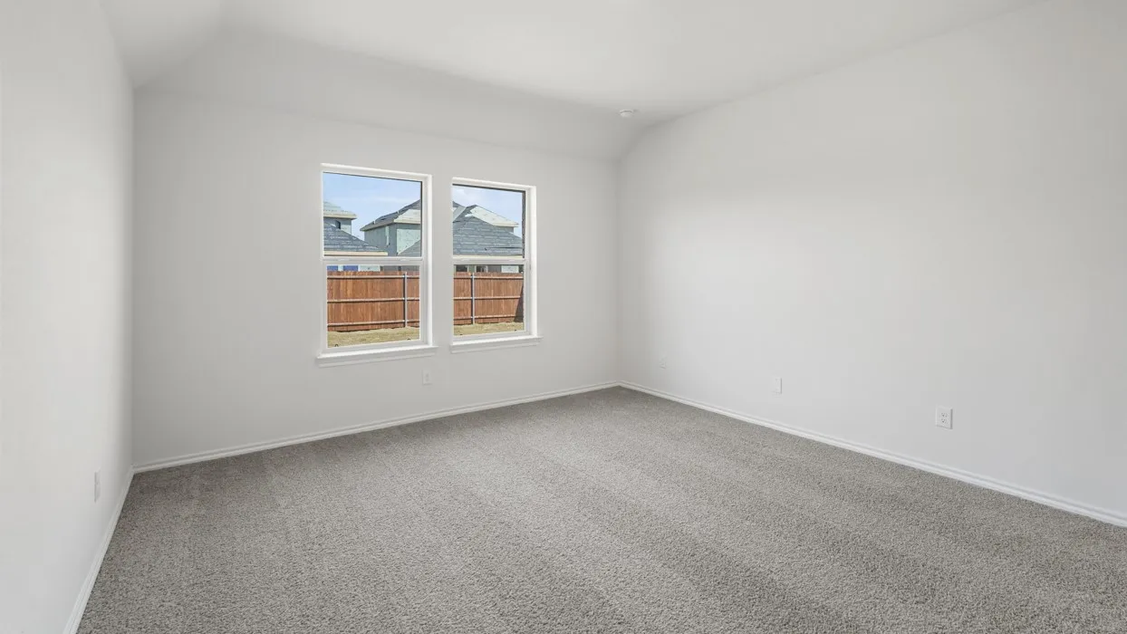 Spacious room featuring neutral carpeting, white walls, and two large windows