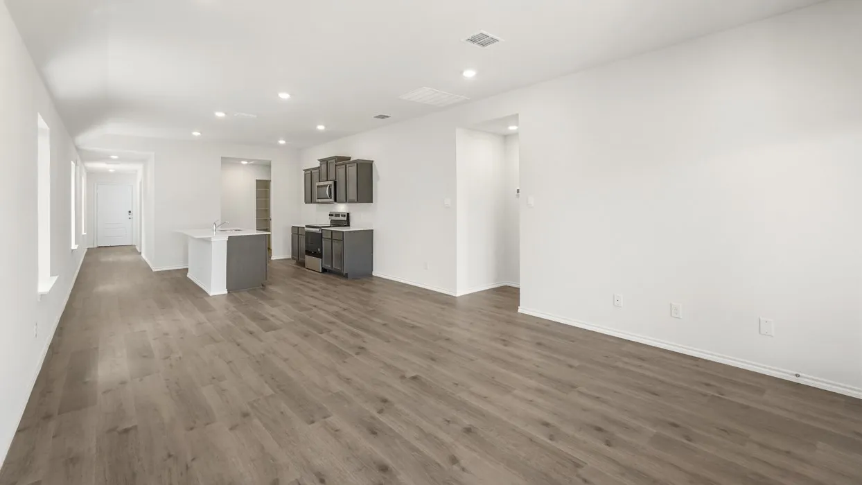 Open-concept living space featuring wood-finish flooring and recessed lighting
