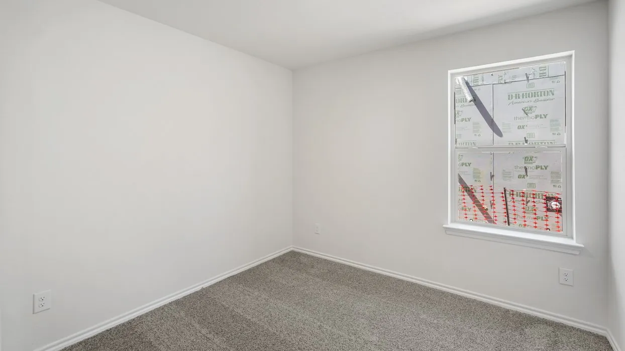 Neutral-toned carpeting and white walls create a versatile interior space