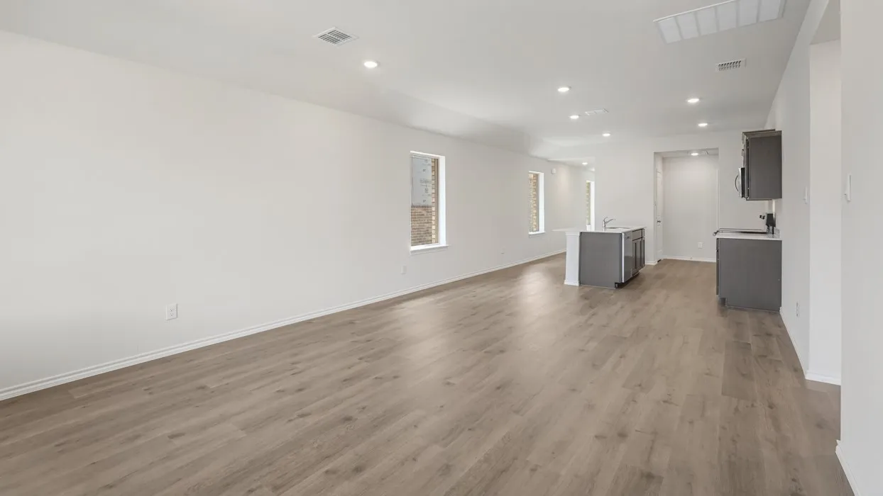 Spacious interior featuring wood-finish flooring, recessed lighting, and white walls