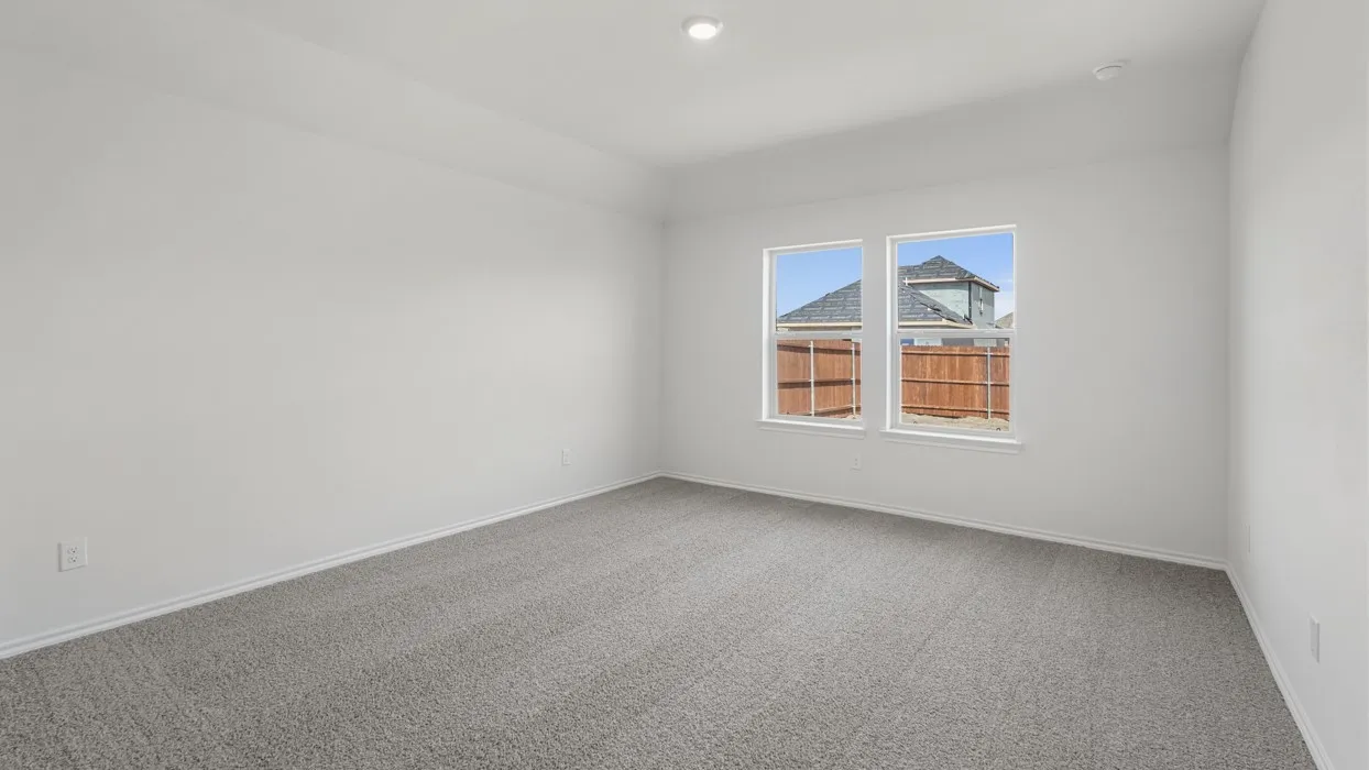 Spacious interior room featuring light gray carpeting, neutral white walls, white trim, and two large windows