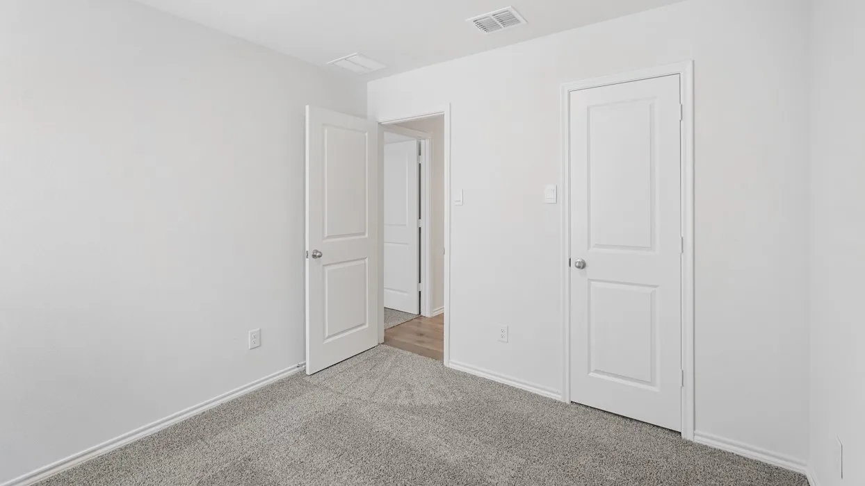 Neutral-toned walls and gray patterned carpet create a versatile backdrop