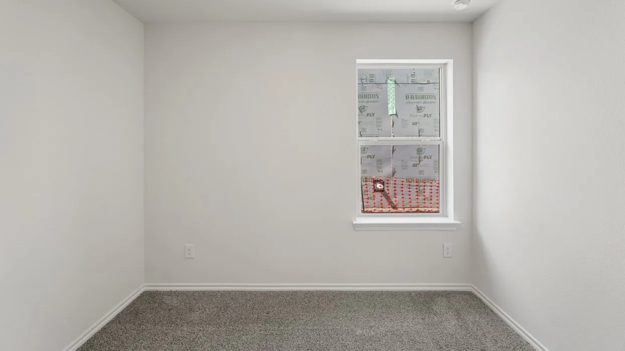 Carpeted room with a double-hung window featuring a white frame and trim