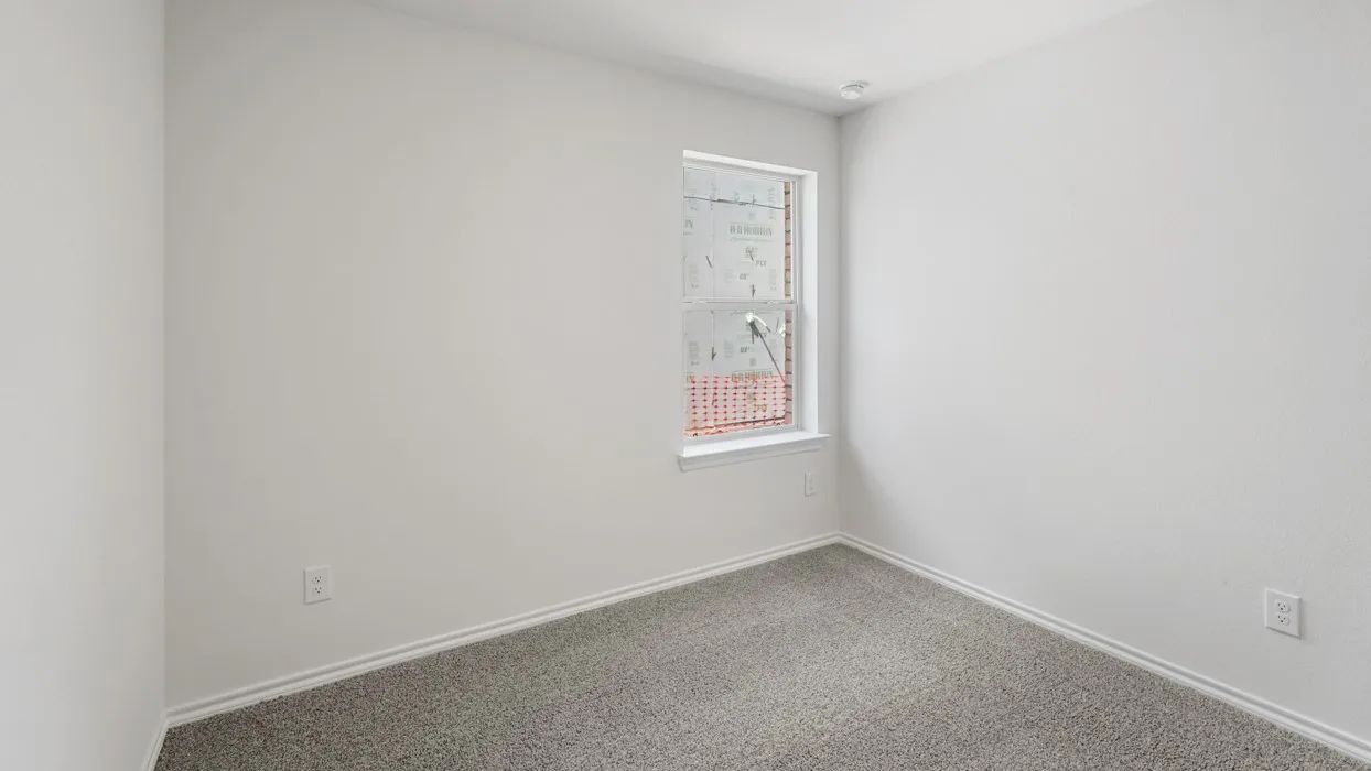 Room featuring a single window with white trim, light gray wall-to-wall carpeting, and white baseboards