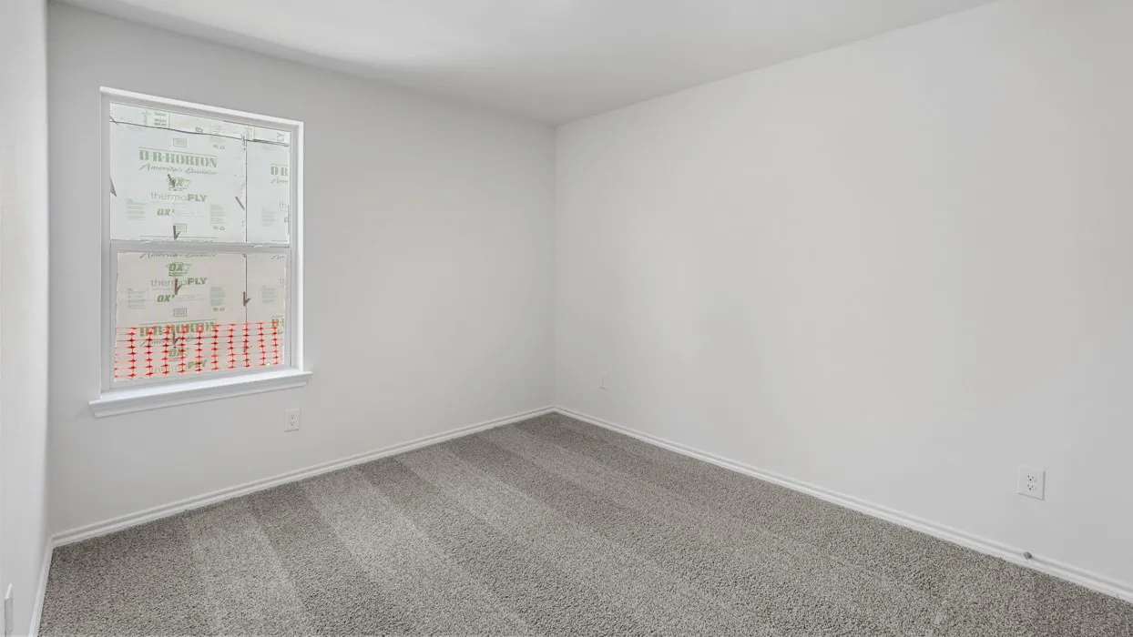 Room featuring a double-hung window, light gray carpet, white baseboards, and a neutral wall color