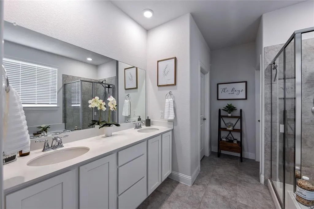 Dual vanity with undermount sinks, chrome fixtures, and light-toned countertops
