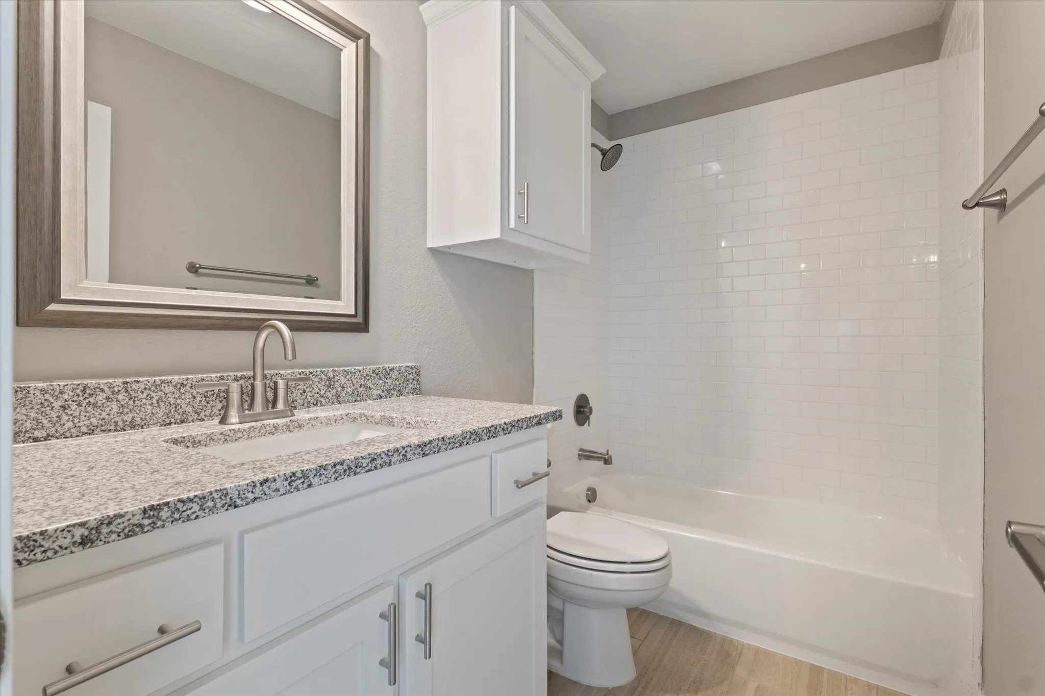 White subway tile shower surround with a built-in tub
