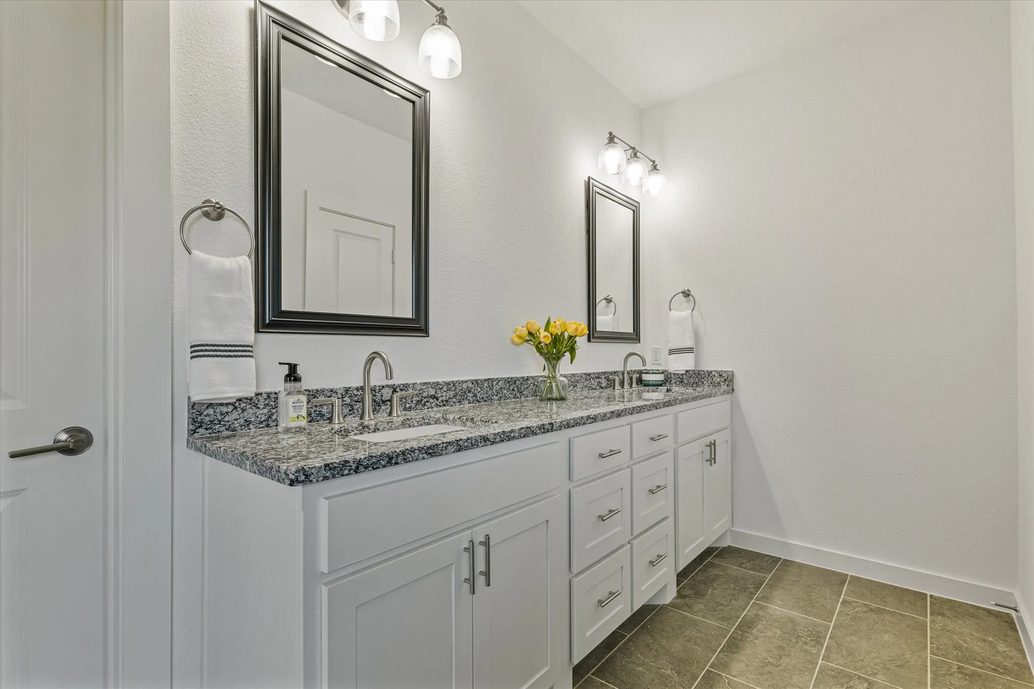Dual vanity with white cabinetry and brushed nickel hardware