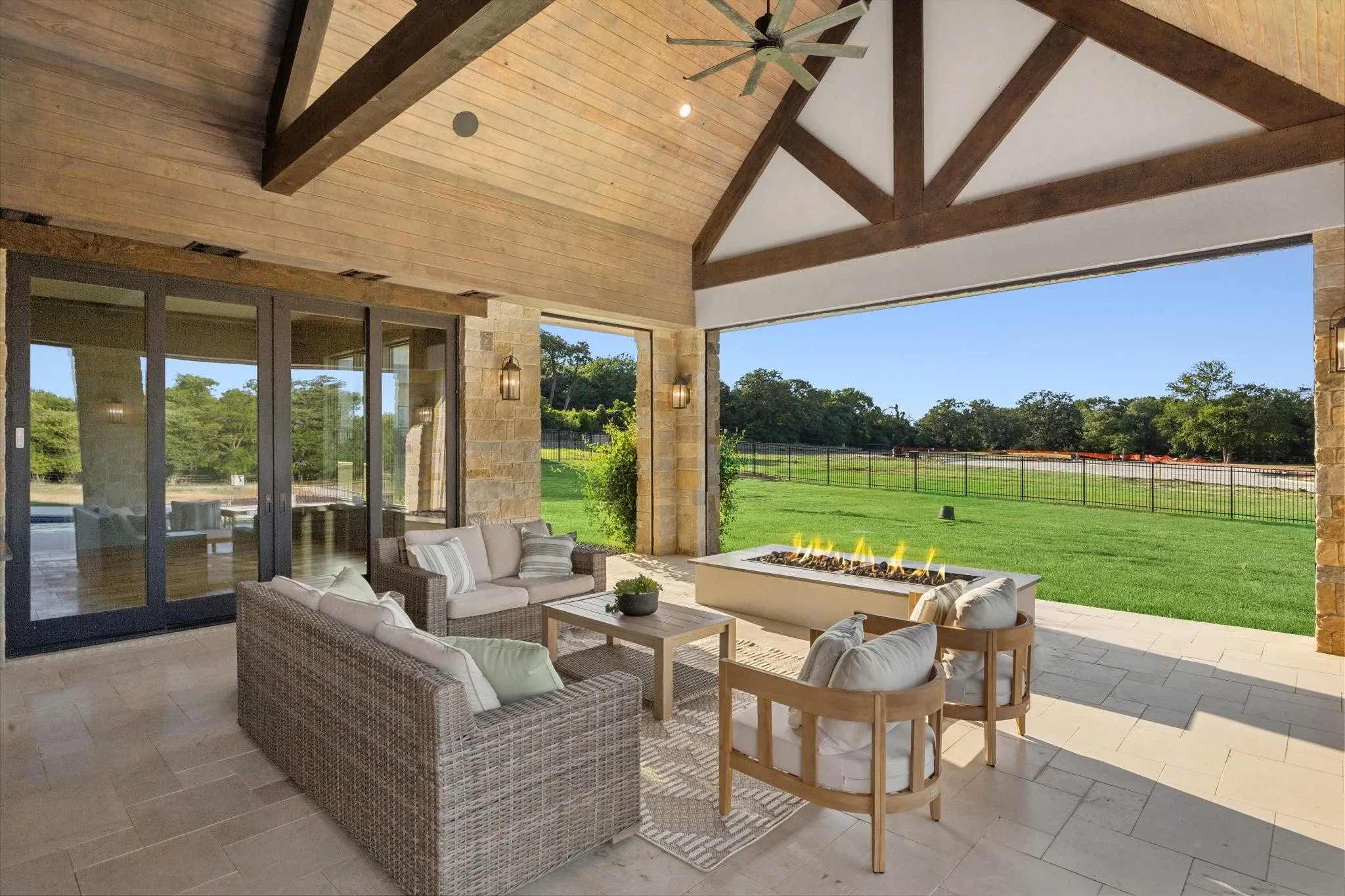 Linear firepit overlooking the lawn; remote screens completely protect the outdoor living space