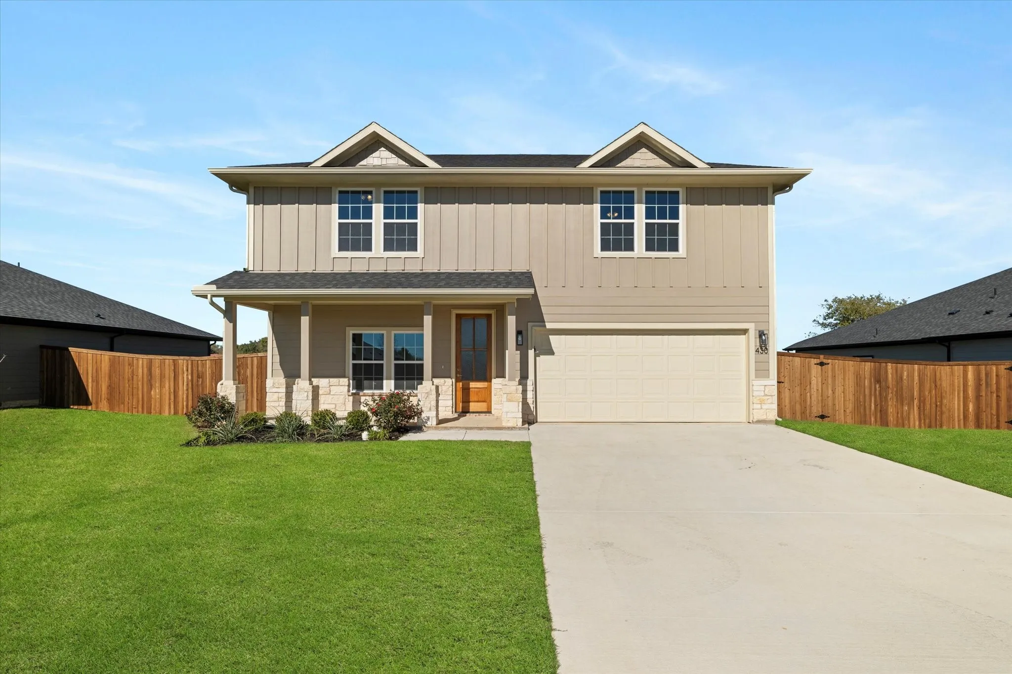 Two-story residence featuring a combination of horizontal siding and vertical board and batten siding