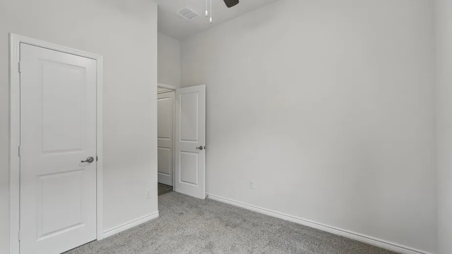 Neutral paint palette and light gray carpeting define this interior space