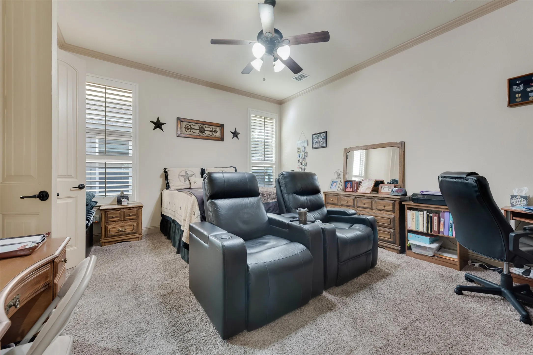 Downstairs Primary Bedroom featuring ceiling fan and ornamental molding